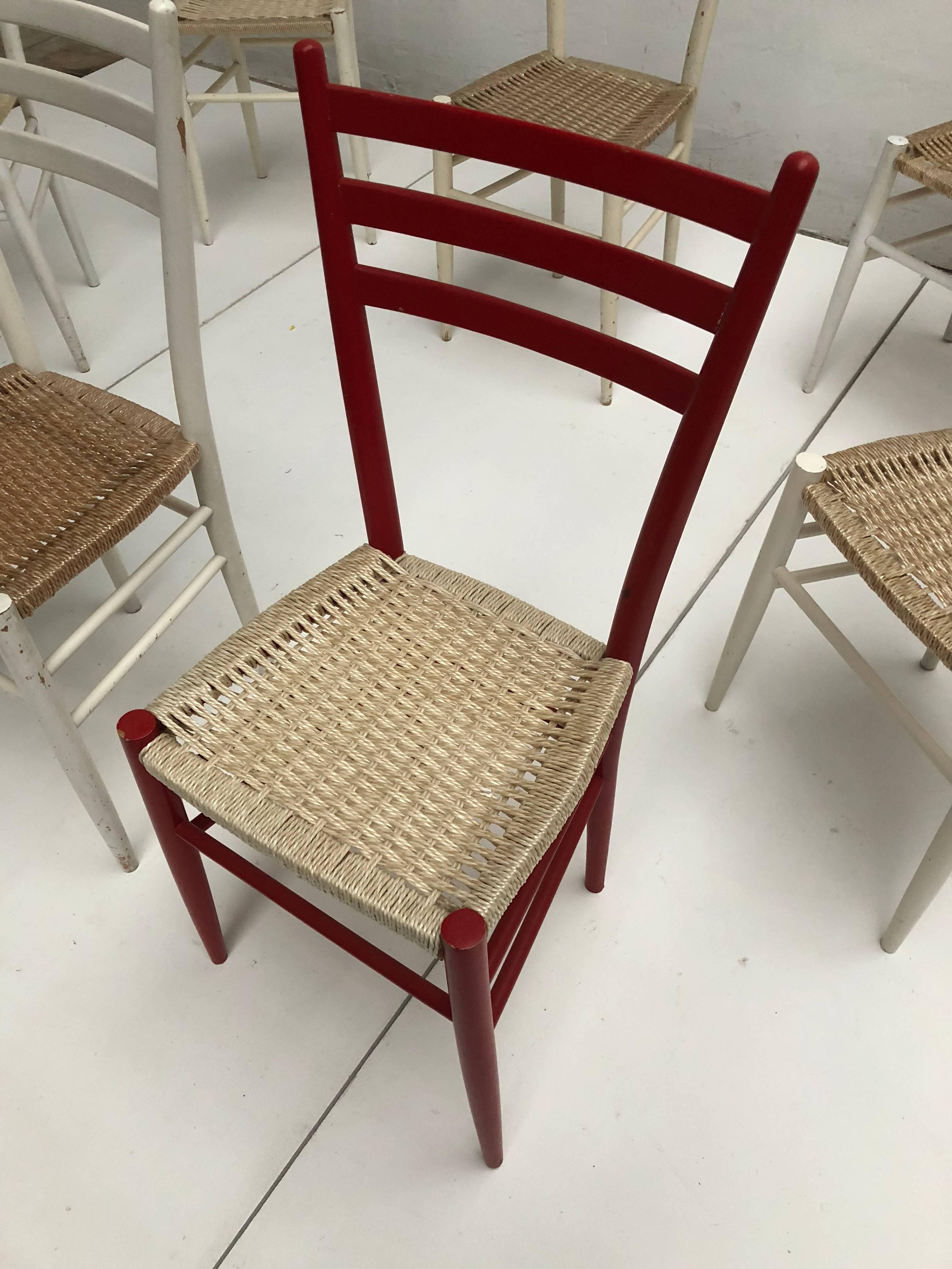 A mixed set of eight vintage Chiavari dining chairs made in Italy in the 1960s-1970s

Black and clear lacquered birch wood frames with plastified paper-cord woven seating 

Most likely produced in the Chiavari area in Italy 

We have collected
