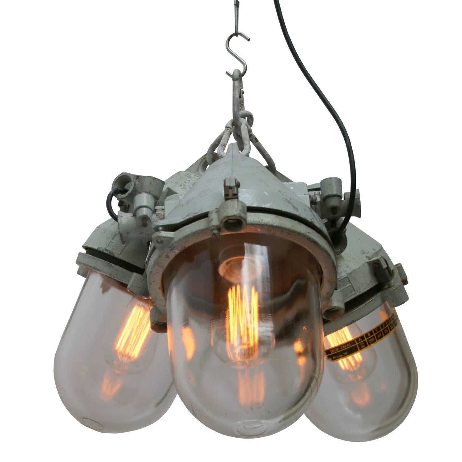 Triple Industrial lamps.
Grey aluminum top, clear glass.

All lamps have been made suitable by international standards for incandescent light bulbs, energy-efficient and LED bulbs with an E26/E27 socket, new wiring CE certified or UL Listed. Max