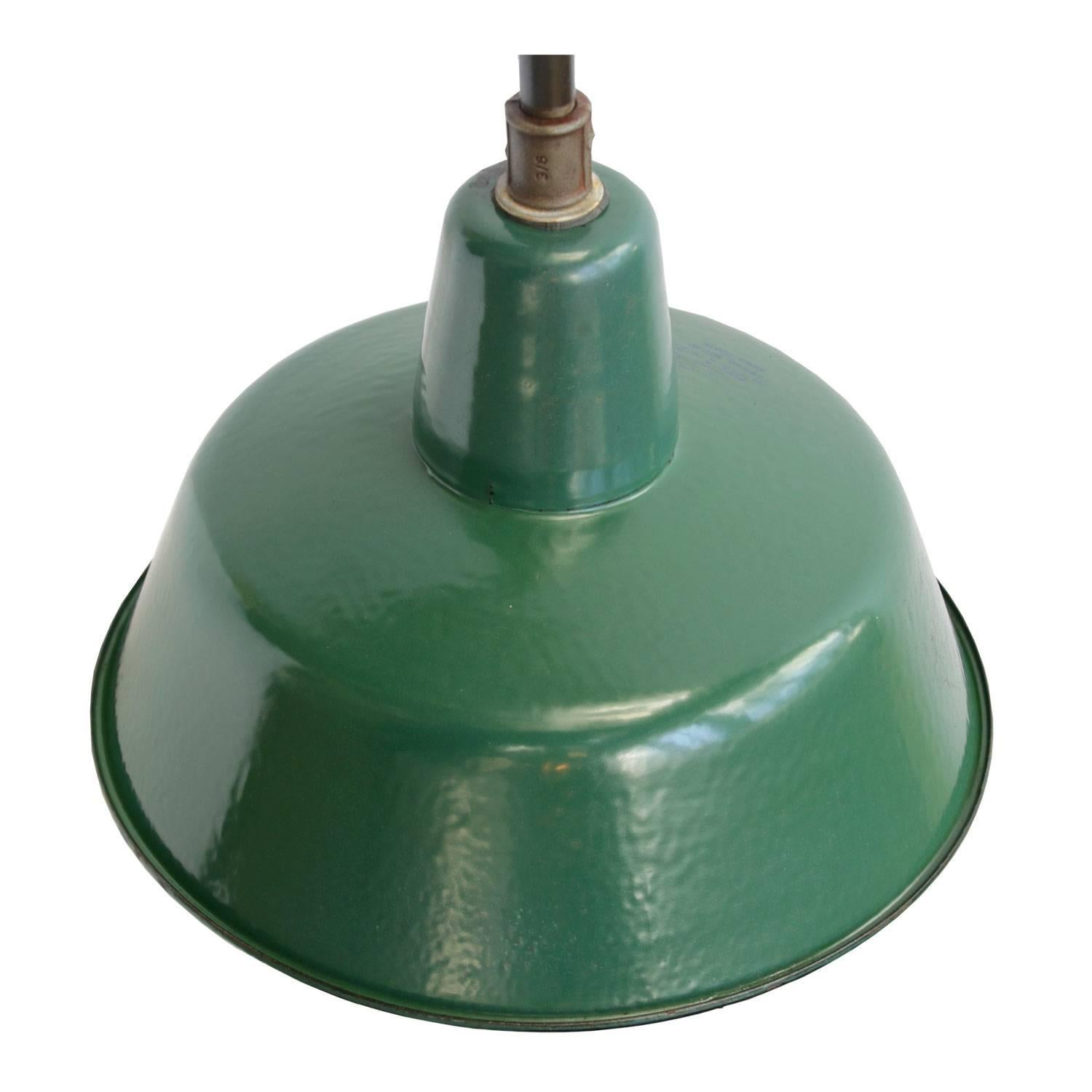 Industrial wall light, green coloured enamel shade, white interior, cast iron arm. 
Diameter cast iron wall piece: 12 cm (4.7 inch) three holes to secure.

Weight: 3.1 kg / 6.8 lb

Priced per individual item. All lamps have been made suitable by