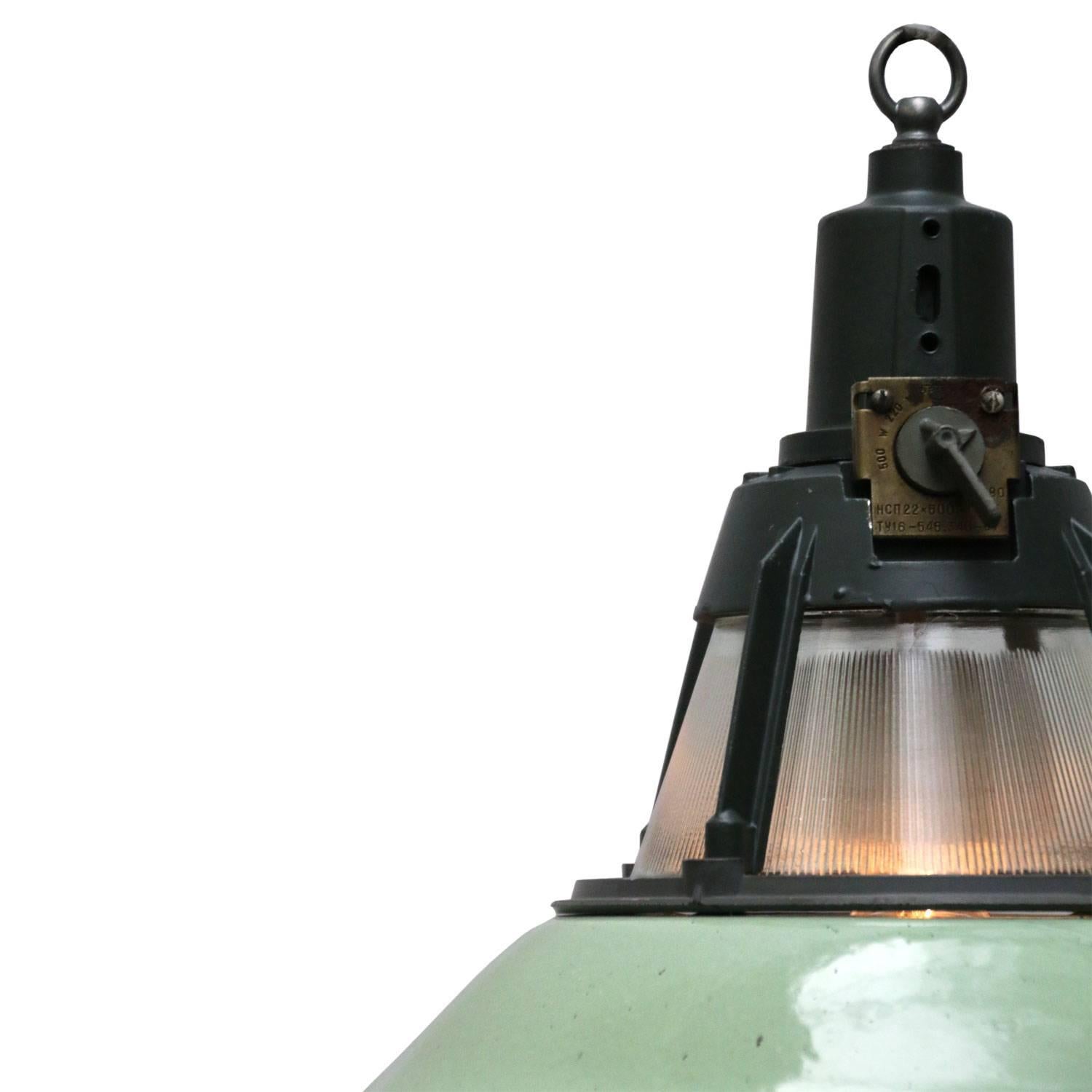 Enamel Industrial pendant. Green enamel shade, white inside.
Dark grey/green cast aluminium top.

Weight: 2.8 kg / 6.2 lb

All lamps have been made suitable by international standards for incandescent light bulbs, energy-efficient and LED