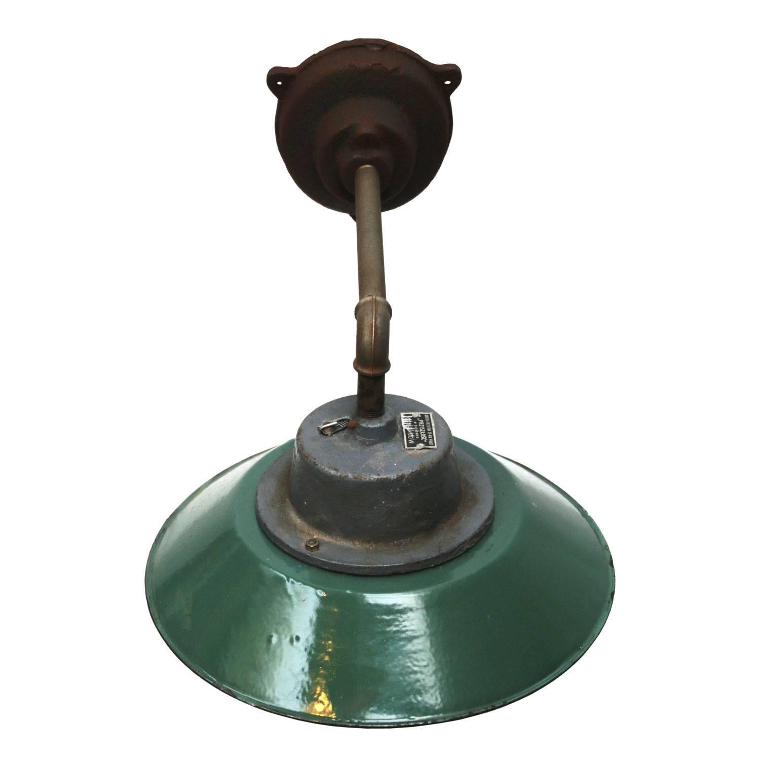 Petrol colored enamel industrial wall light with white interior. Clear glass.
Diameter cast iron wall mount: 12 cm, three holes to secure,

Weight: 5.5 kg / 12.1 lb

For use outdoors as well as indoors. 

All lamps have been made suitable by