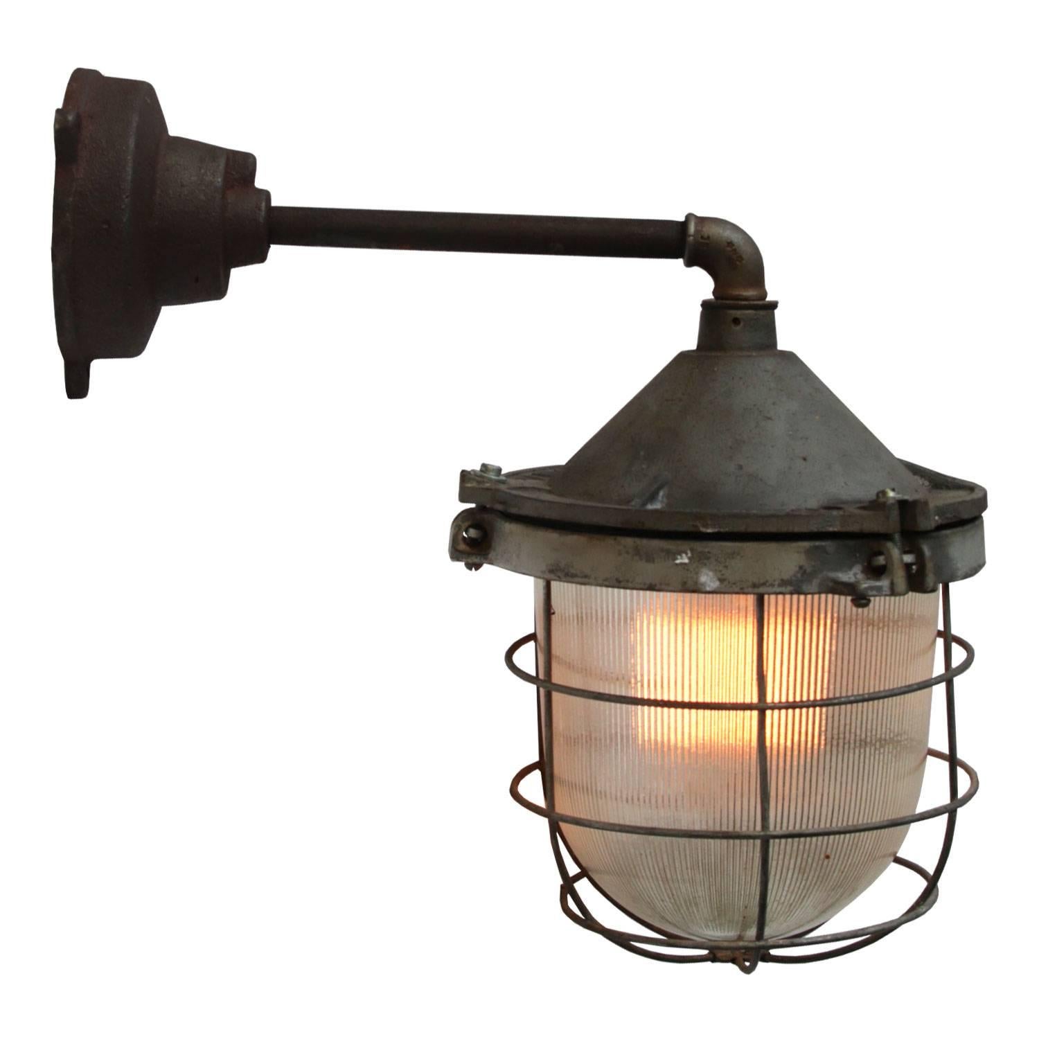 Cast iron Industrial wall light. Holophane glass. 

Weight: 7.5 kg / 16.5 lb. 

For use outdoors as well as indoors. 

All lamps have been made suitable by international standards for incandescent light bulbs, energy-efficient and LED bulbs. E26/E27