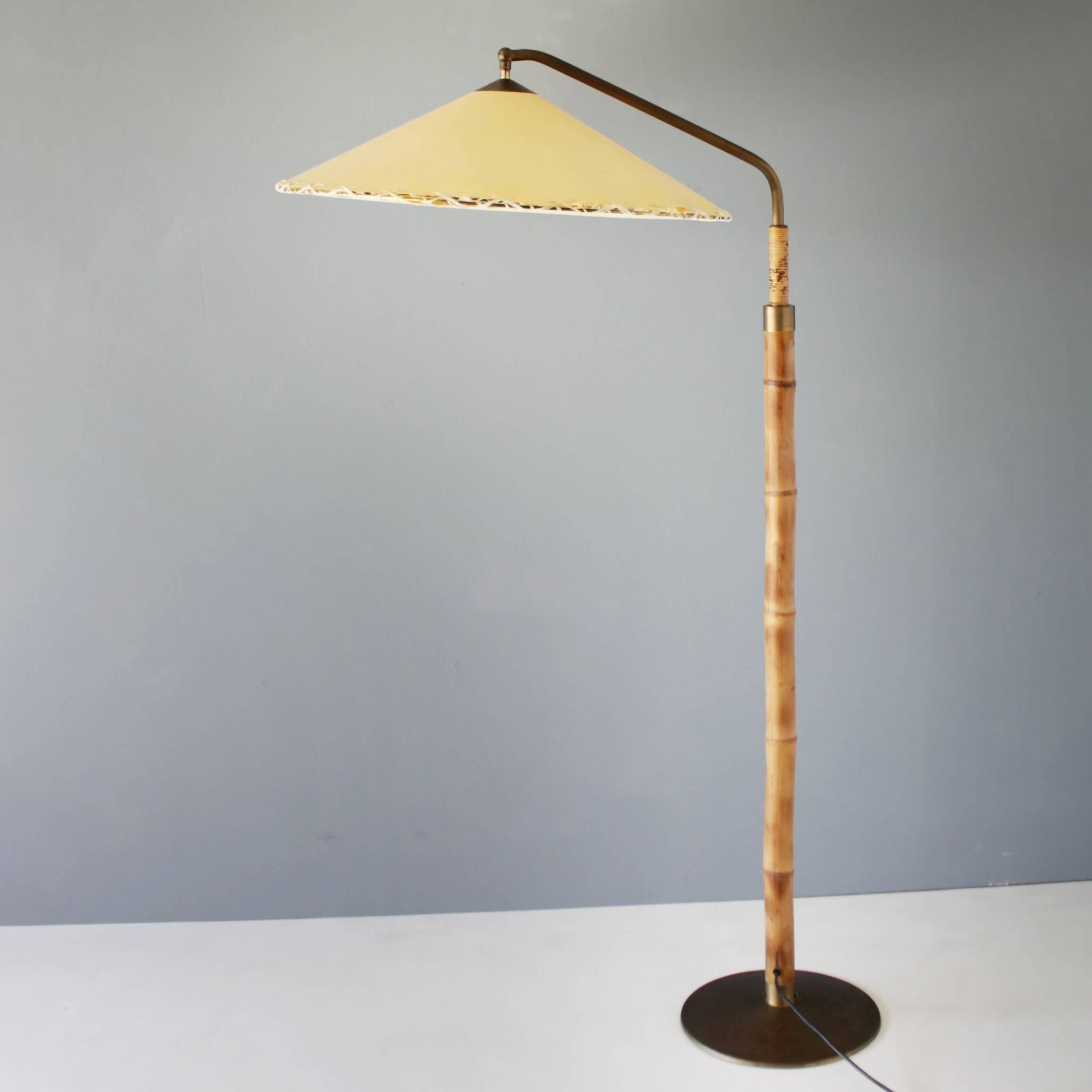 Rare floor lamp by the German designer Pitt Müller. Manufactured by Müller Werkstätten Bonn in the early fifties. Bamboo, brass and with a paper shade. The shade is been restored. Marked with a label. Adjustable in height. Dimensions: Height
