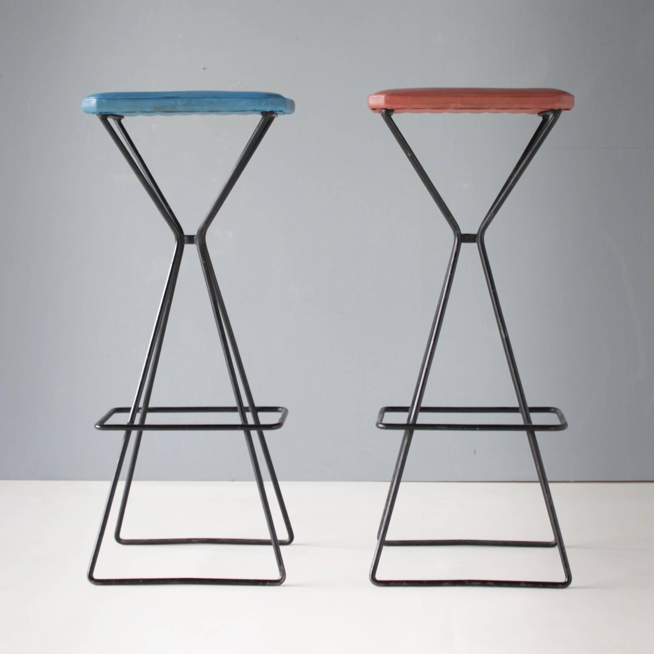 Pair of Dutch sculptural bar stools, steel frame with faux leather seats.