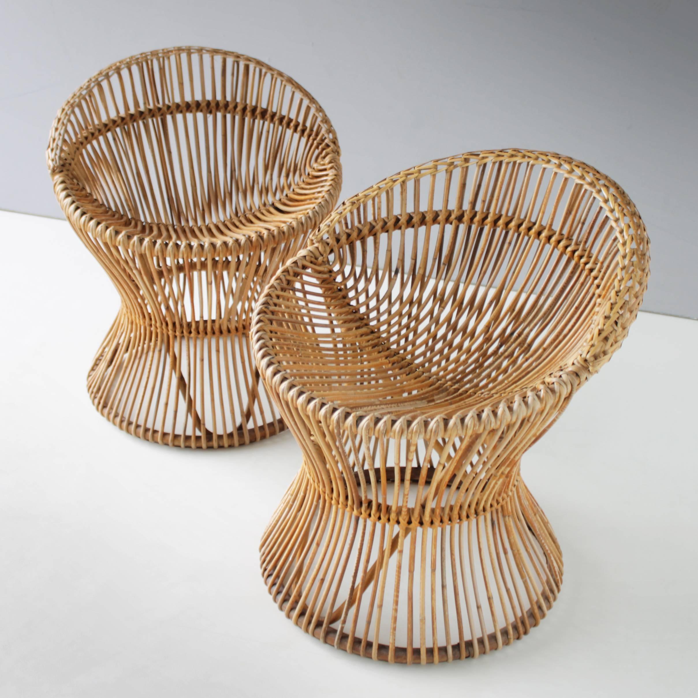 Pair of very rare rattan chairs attributed to Franco Albini for Bonacina Italy. Top condition. Measurements height: 23.6 in. (60 cm), width: 20.4 in. (52 cm), depth: 22.0 in. (56 cm) and seat height: 15.7 inches (40 cm).
