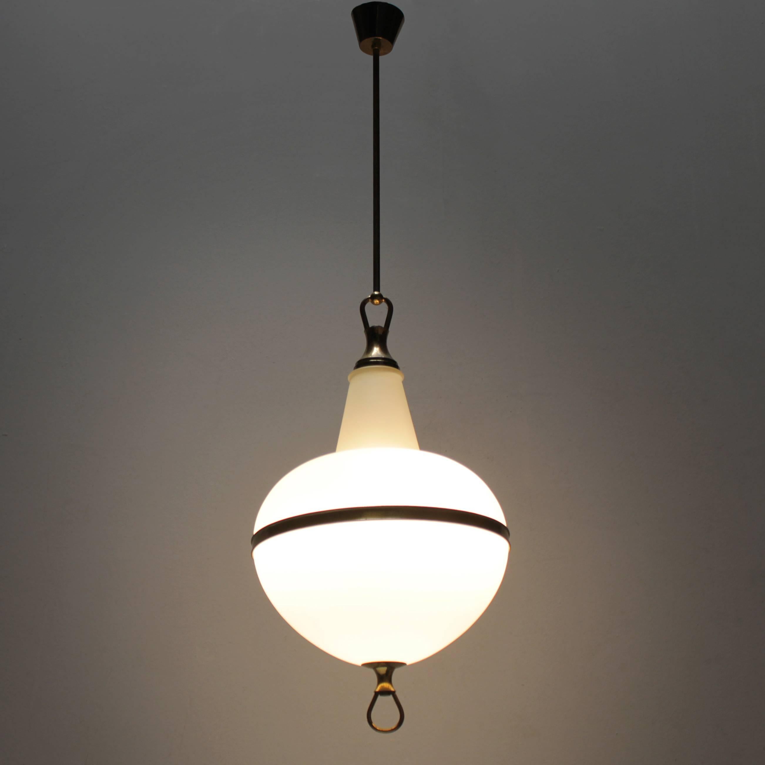 Impressive Italian lantern executed in white cased glass and fitted with high quality brass parts. This beautifully made pendant lamp holds three light bulbs.
Measures: Height from ceiling till drop 45.3 in. (115 cm), diameter 13.6 in. (34.5 cm),