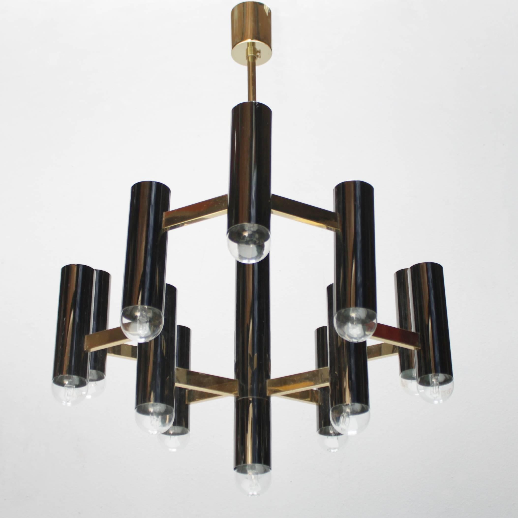 Pair of rare black and brass chandeliers with each 13 light bulbs. Design by Gaetano Sciolari for S.A. Boulanger Belgium. Marked. Diameter 20.9 in. (53 cm). They have a different height, the height is 24.4 in. (62 cm) from ceiling till drop and the