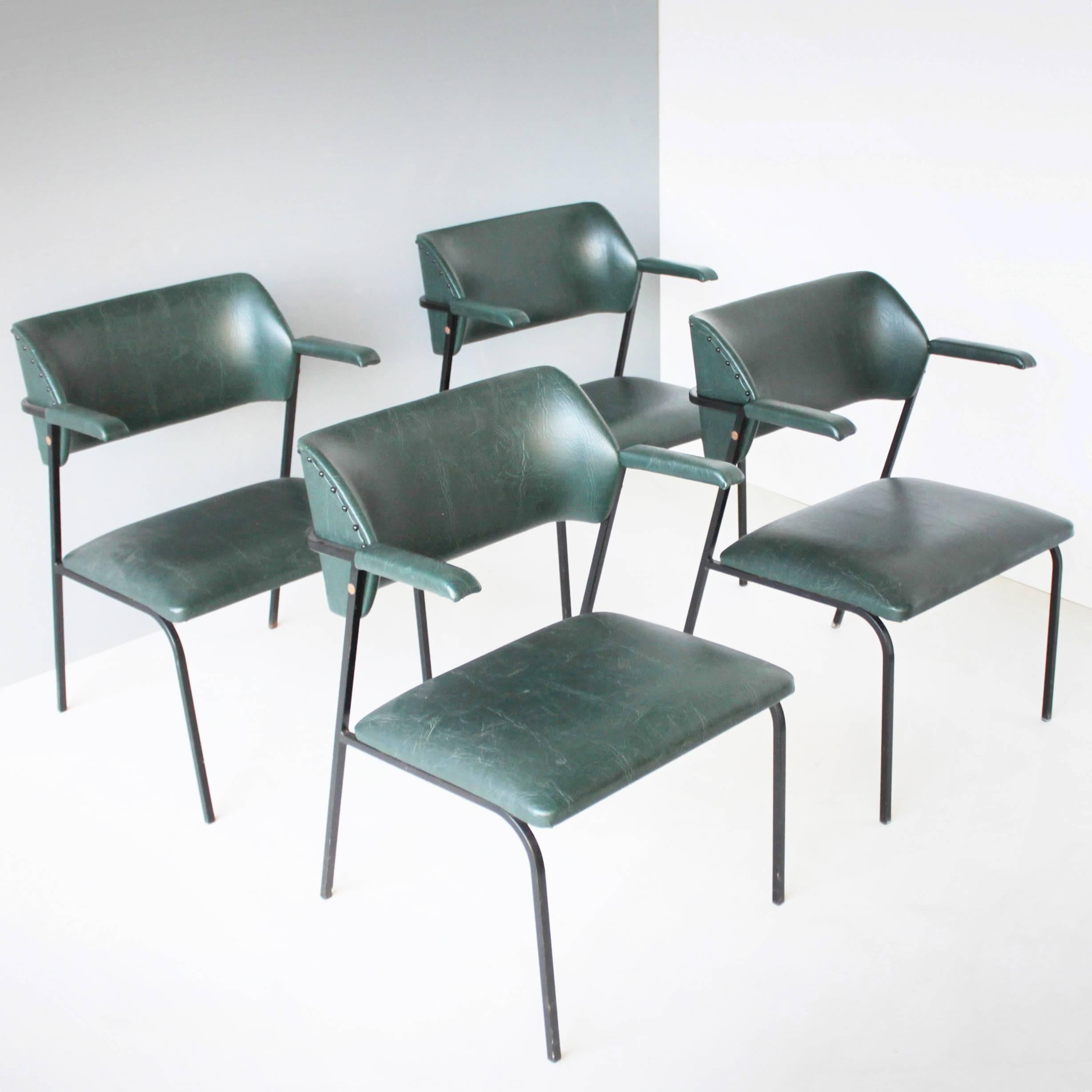 Four (4) dark green faux leather chairs in the style of Jacques Adnet. These four elegant armchairs come probably from Belgium or France.
Dimensions: Height 29.1 in. (74 cm), width 21.0 in. (53,5 cm), depth 20.5 in. (52 cm), seat height: 16.5 (42
