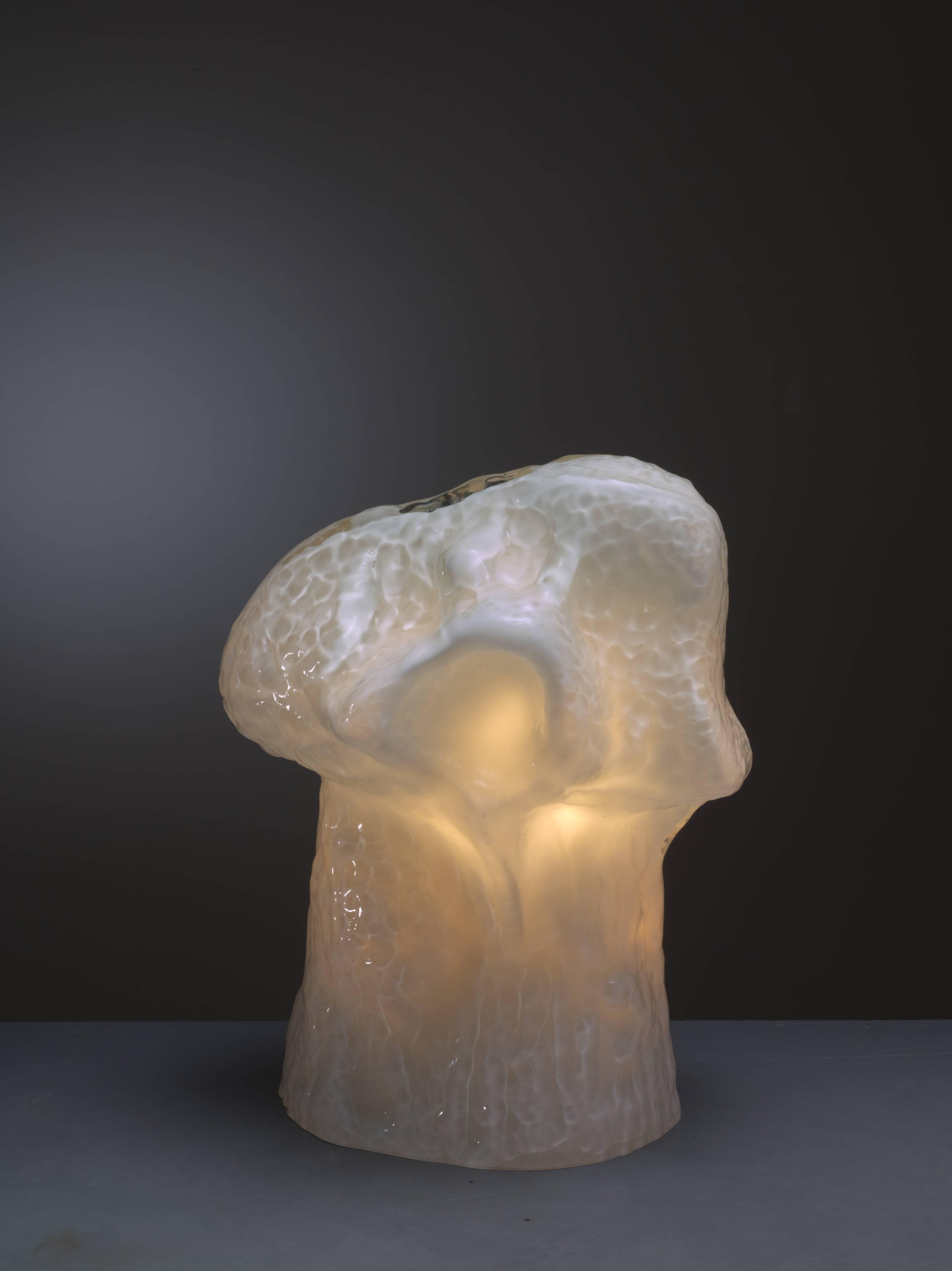 A sculptural table lamp, made of white Murano glass with three-light bulbs inside, that can be turned on and off individually. The lamp was designed by Carlo Nason for Mazzega in the 1960s.