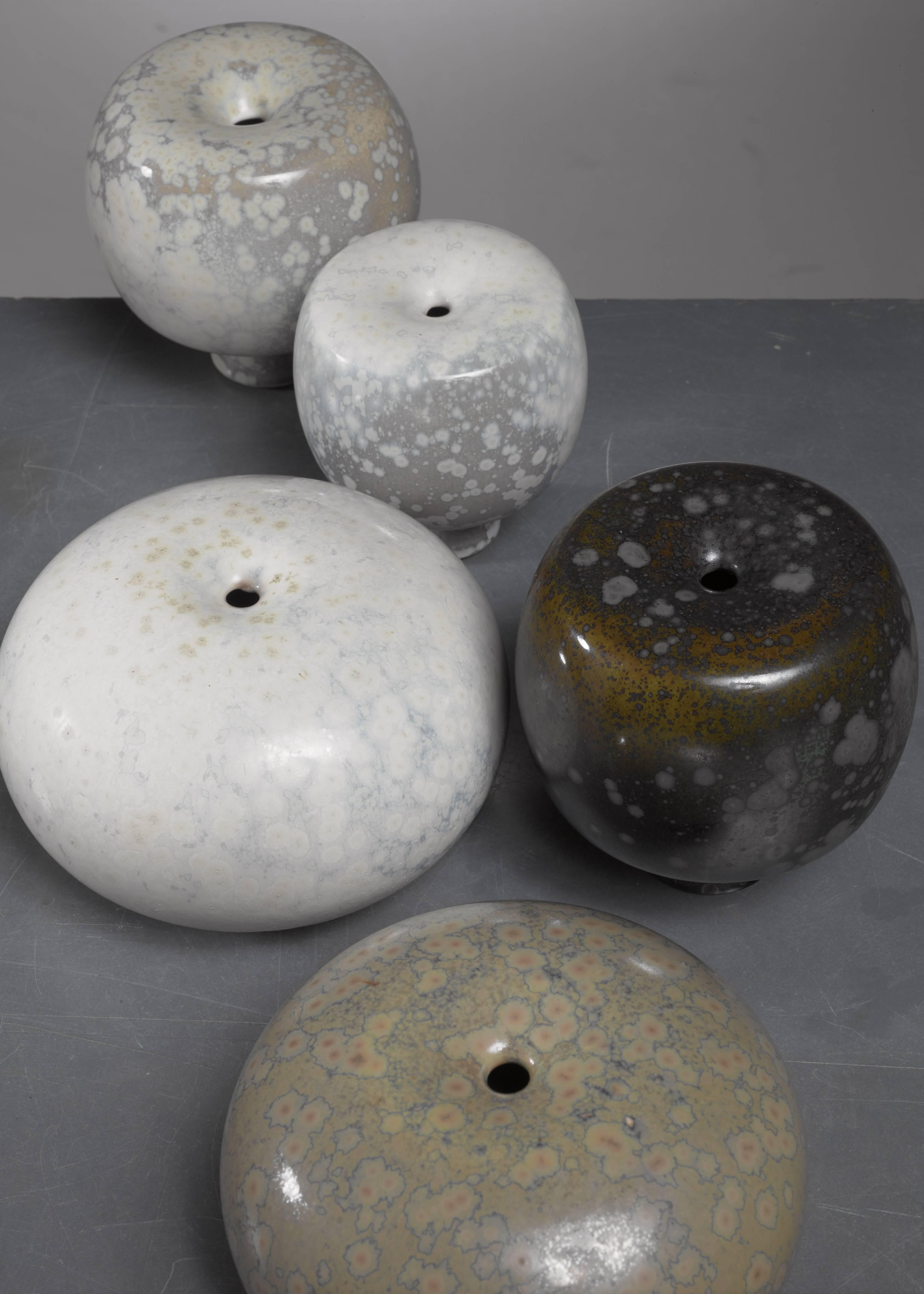A set of five small crystal glazed ceramic vases by German ceramist Willi Hornberger (1932-1995).

The smallest piece is 10 cm high with a 9 cm diameter. The two largest pieces are 9 cm high with a 14 cm diameter. Signed by Hornberger and in a