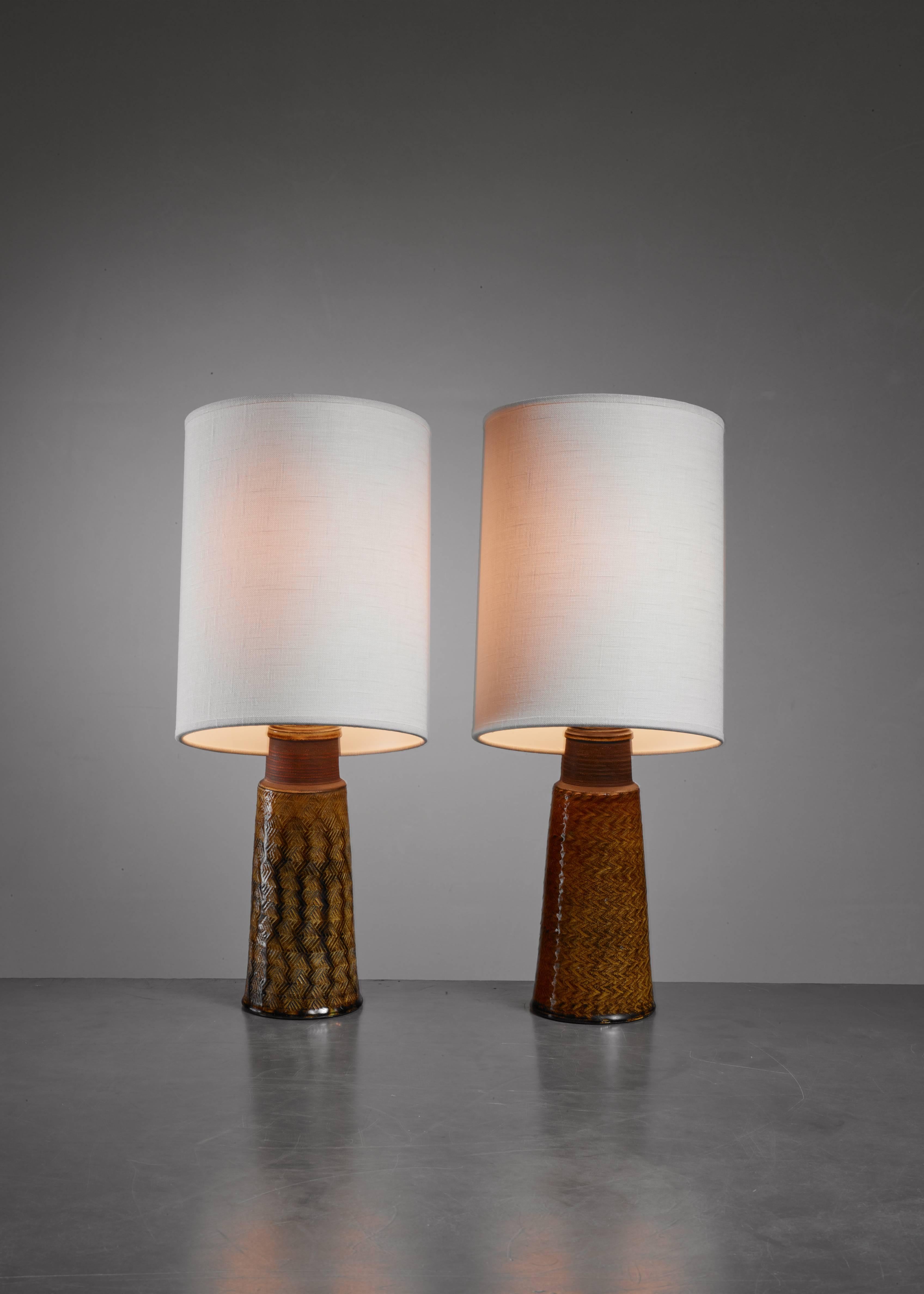 A pair of ceramic table lamps by Kähler. They have a different, but matching yellow-brown glazing with a beautiful fishbone pattern. The measurements stated are of the lamps without the shade. Signed by Kähler and in an excellent condition.


 