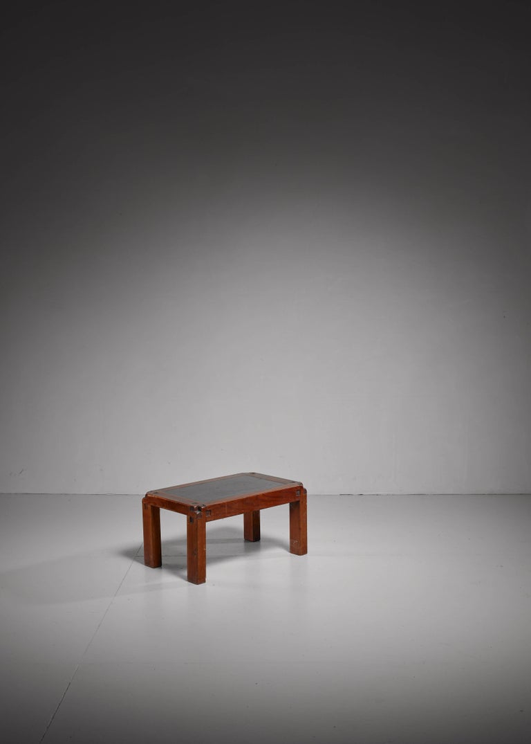 A wooden Pierre Chapo model 'T18' coffee table with a top made of enameled lava stone.
 