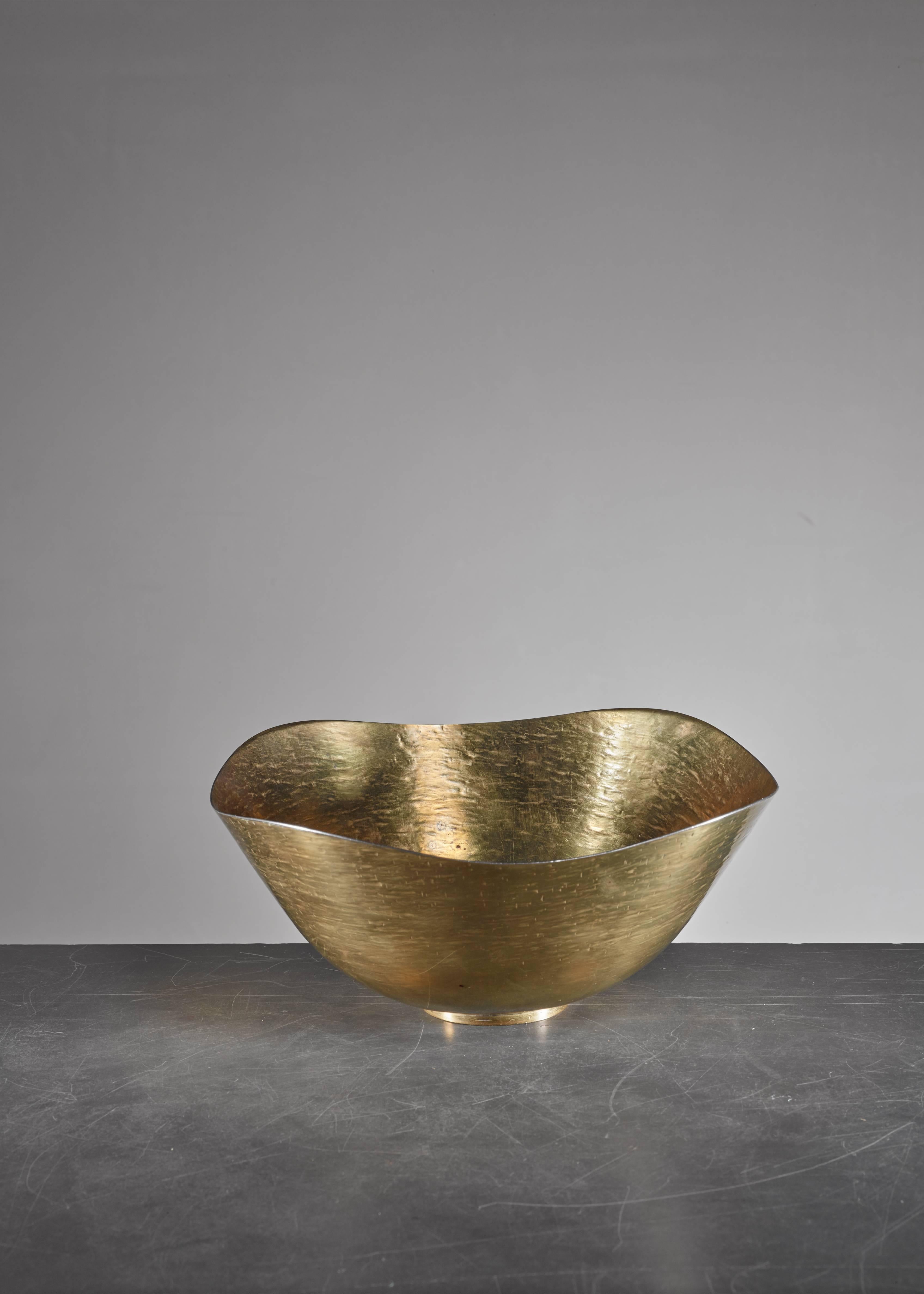 A hand-hammered brass bowl by Hayno Focken.

Focken (1905-1968) was a metalworker and silversmith who was associated with the ideas of the Deutscher Werkbund and Bauhaus in the 1930s. Fockeh received his education at the Burg Giebichenstein