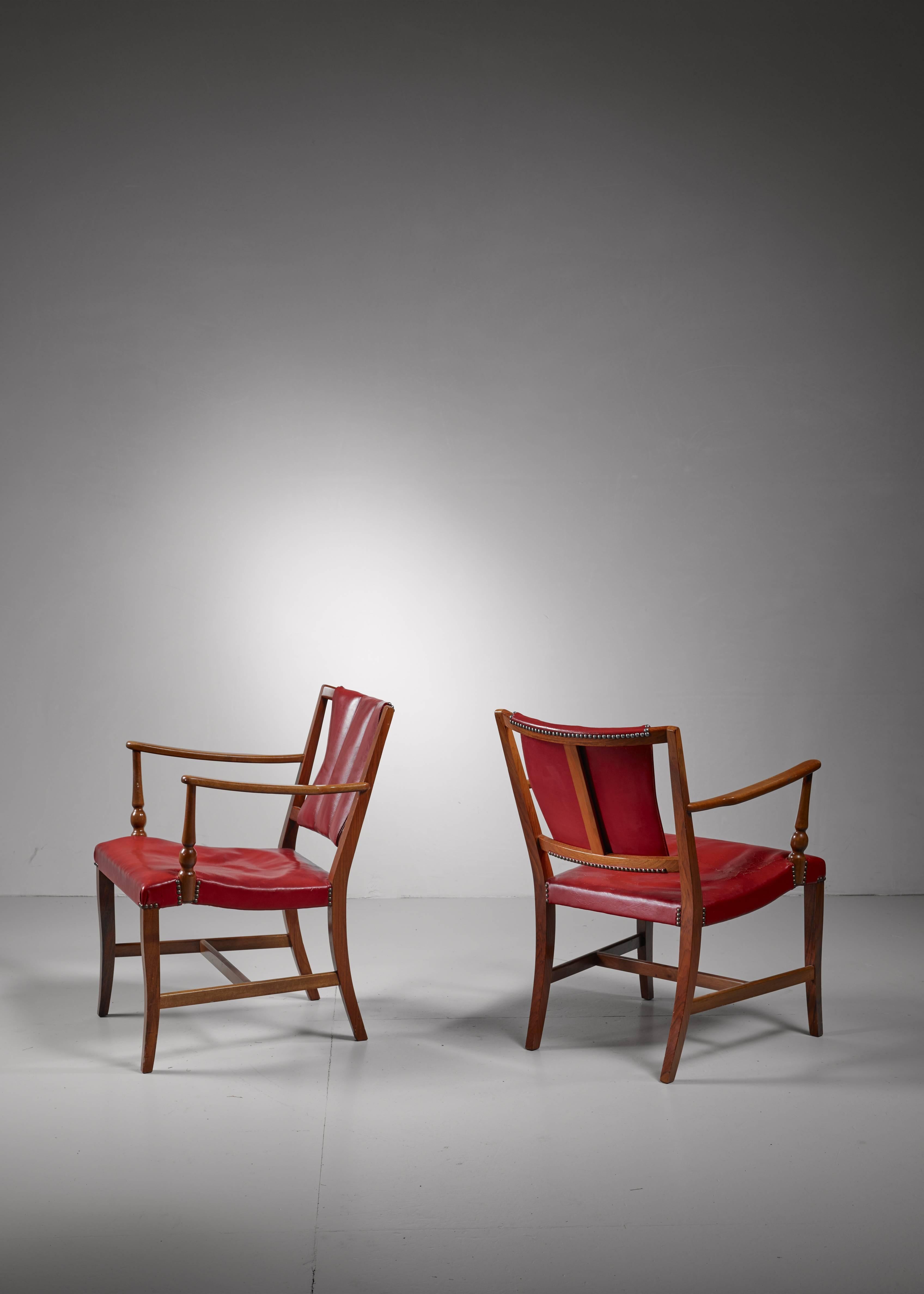 A pair of armchairs designed in 1948 by Josef Frank for Svenskt Tenn. These model 2067 chairs are made of cherry wood with a red leather seating and backrest.

*This pair is curated for you by Bloomberry *