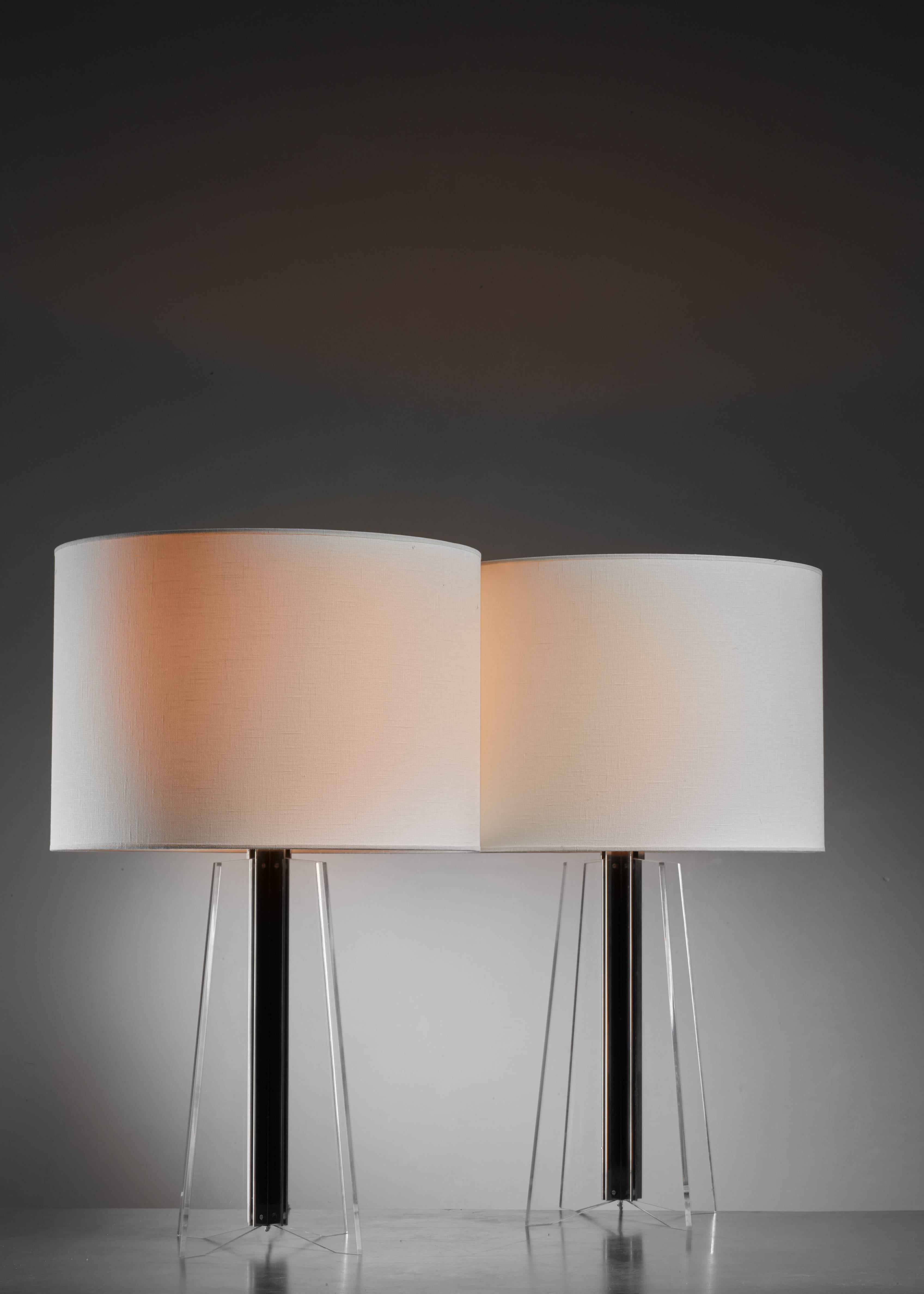 A pair of German midcentury table lamps on a cruciform plexiglass base with a metal core. The measurements stated are of the lamps without a shade.
