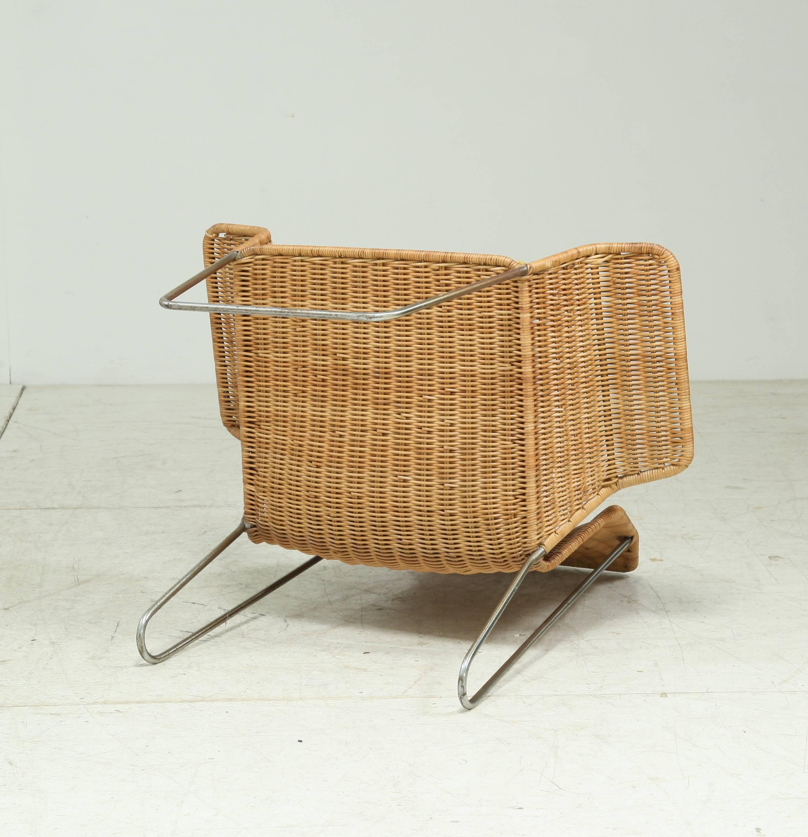 Mid-20th Century Dutch Design rattan armchair on a bent iron frame, 1960s For Sale