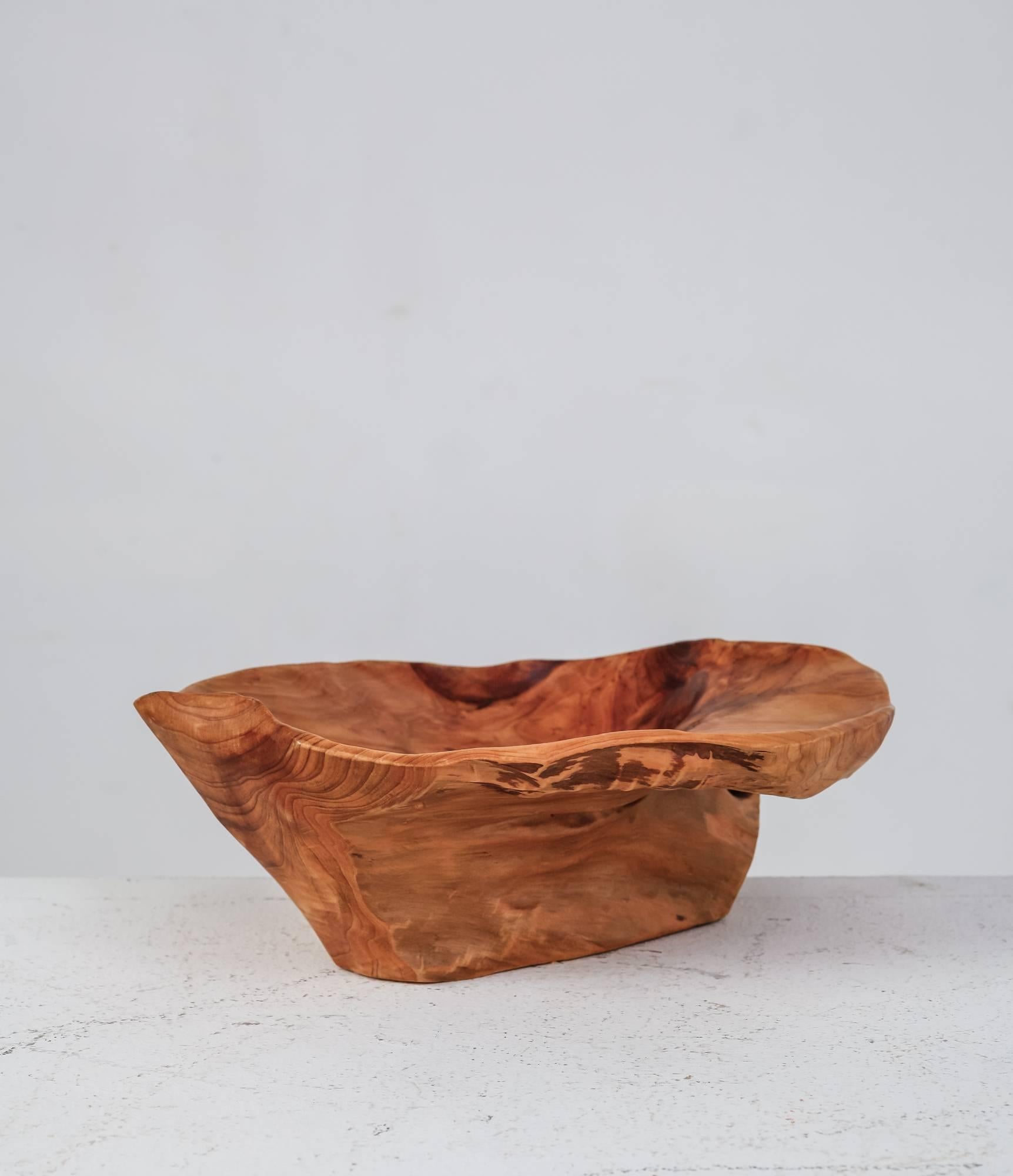 A sculptural, carved bowl by an American craftsman, made of a light root wood. The bowl is signed with 'CC 72,' presumably the initials of the artist and the year of production.
