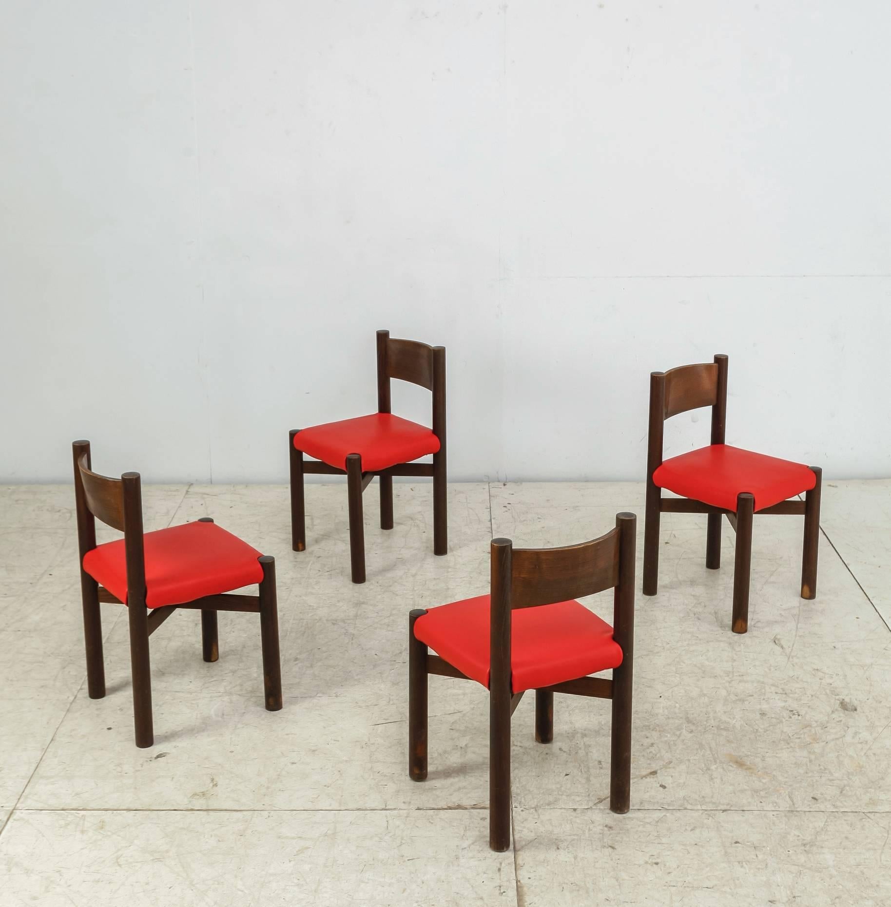 A set of four 'Courchevel' chairs by Charlotte Perriand chairs, made of an oak frame with a rush seating. The removable leather covers are tailor-made in our in-house atelier and based on original leather protection covers we found on Perriand