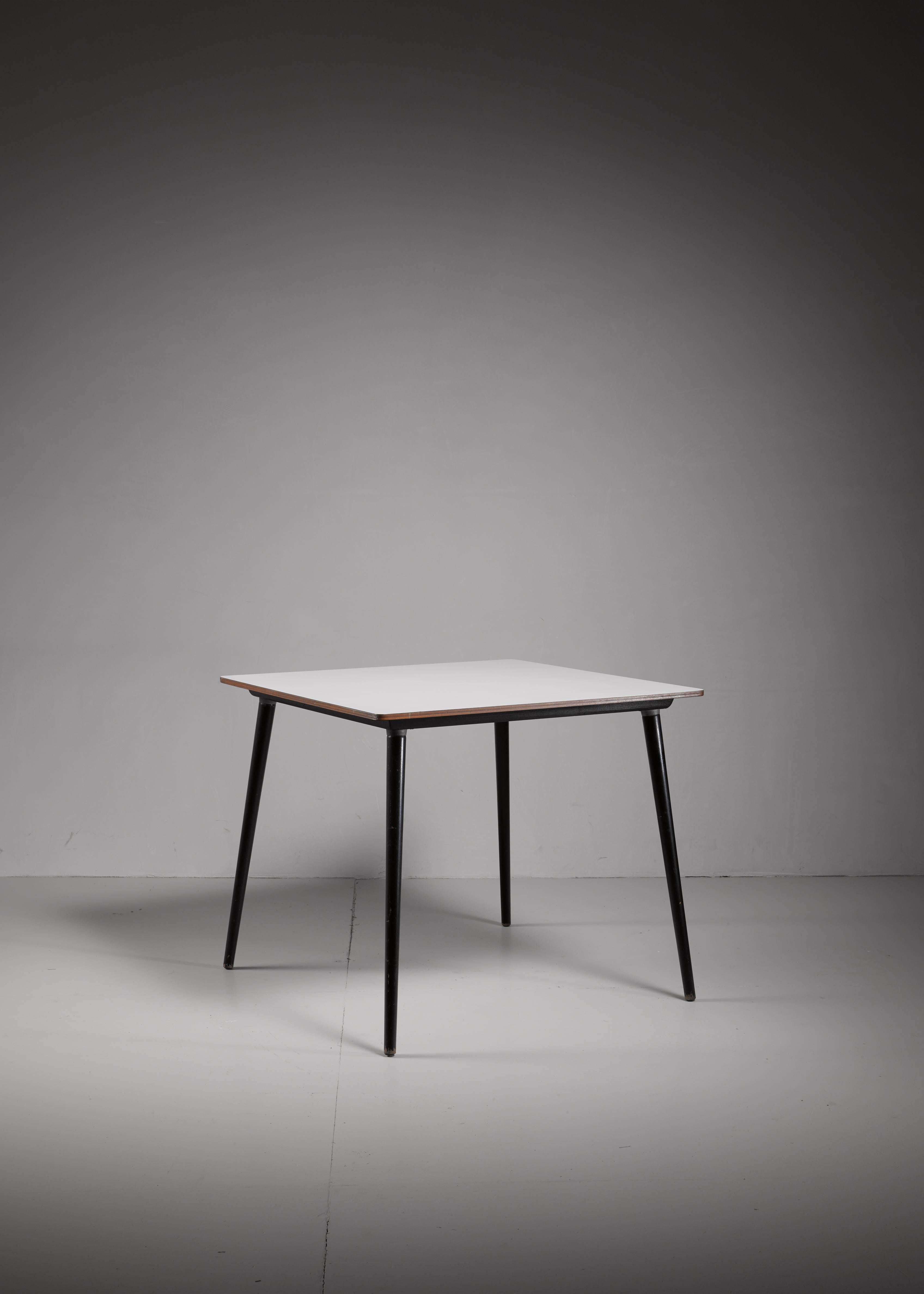 A small wooden model DTW-40 table, designed by Charles Eames for Herman Miller. It has a white laminated top with wonderful deep dark blue dowel legs. The legs can be unscrewed for easy transport and storage.

Please contact us for your shipping