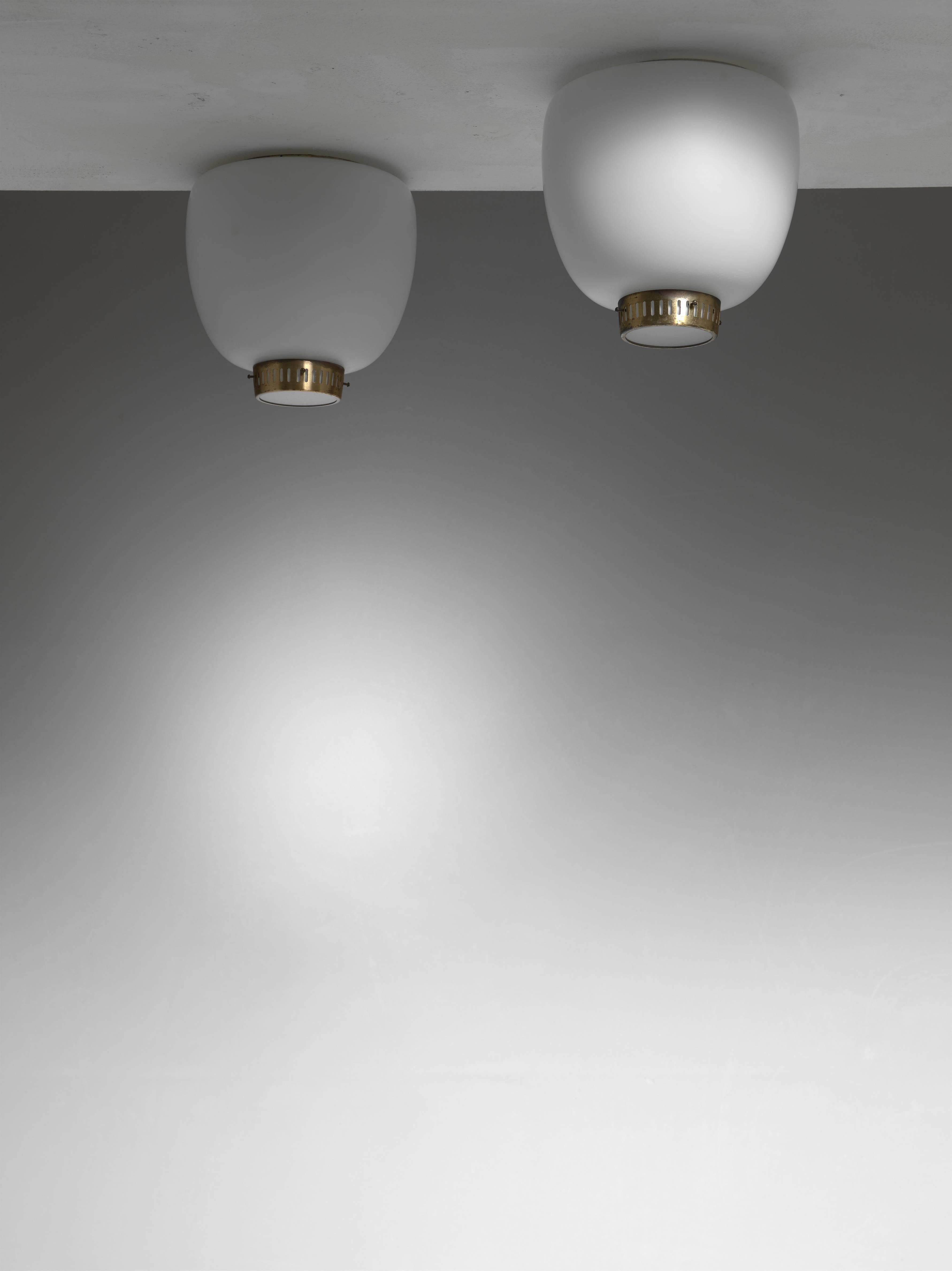 A pair of model 'Kina' opaline glass and brass flush mount ceiling lamps by Bent Karlby for Lyfa.

The lamps are made of an opaline glass shade and a brass ring underneath with a frosted glass diffuser.


