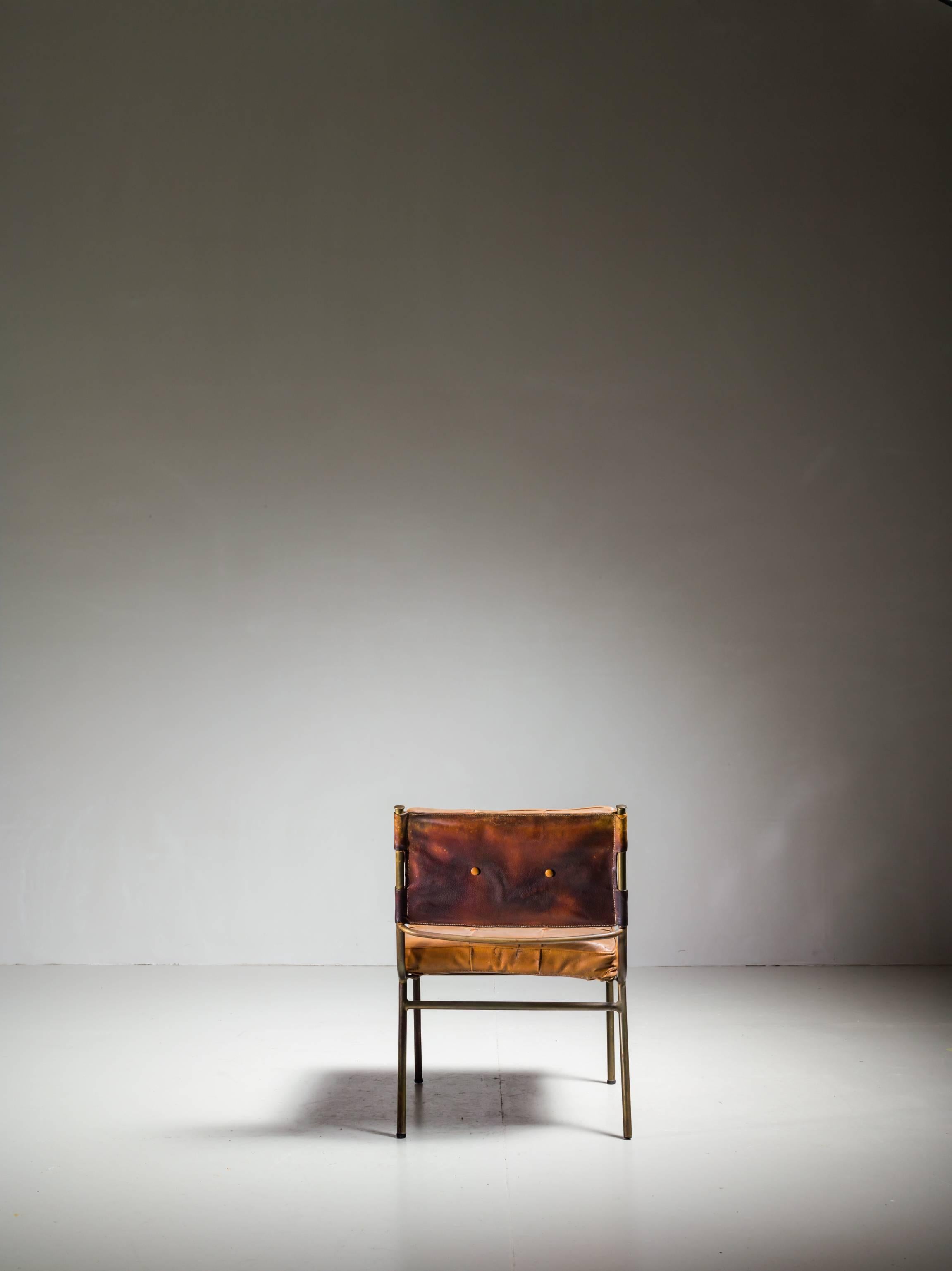 A rare and published Mathieu Matégot chair. The chair is made of a brass frame with a padded leather cushion and backrest. The backrest tilts back slightly, for a comfortable seating position.
The chair is in a beautiful condition.