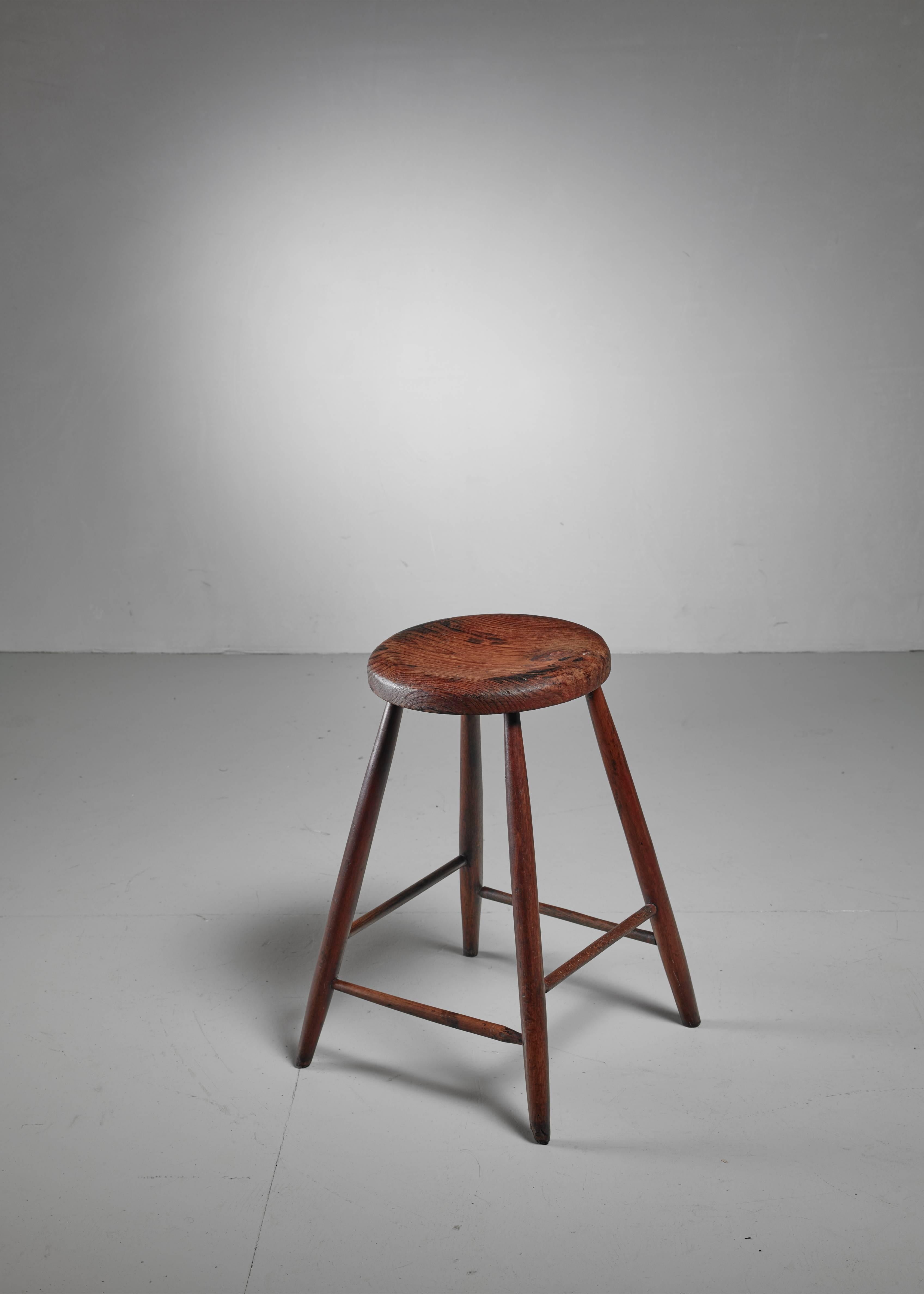 A unique, American wooden studio crafted bar stool from the turn of the century. An interesting detail is that one of the spindles has been clearly recut, which makes it possible that the maker used recycled parts for this stool.