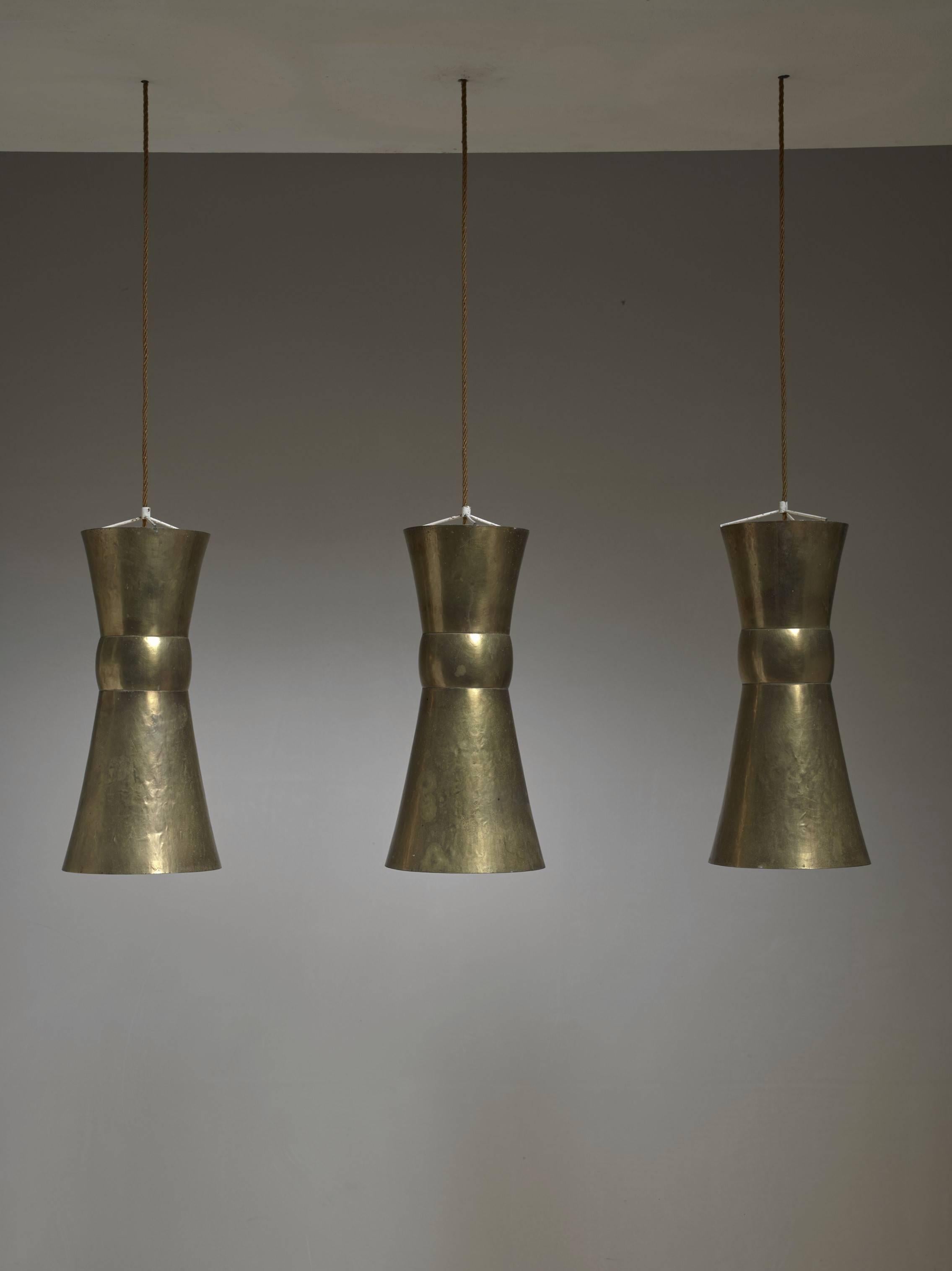 A set of three unique hand-hammered brass pendant lamps by the important German artisan Hayno Focken. These lamps are unique pieces made for a church in the Schwarzwald and come with full documentation.

Focken (1905-1968) was a metalworker and