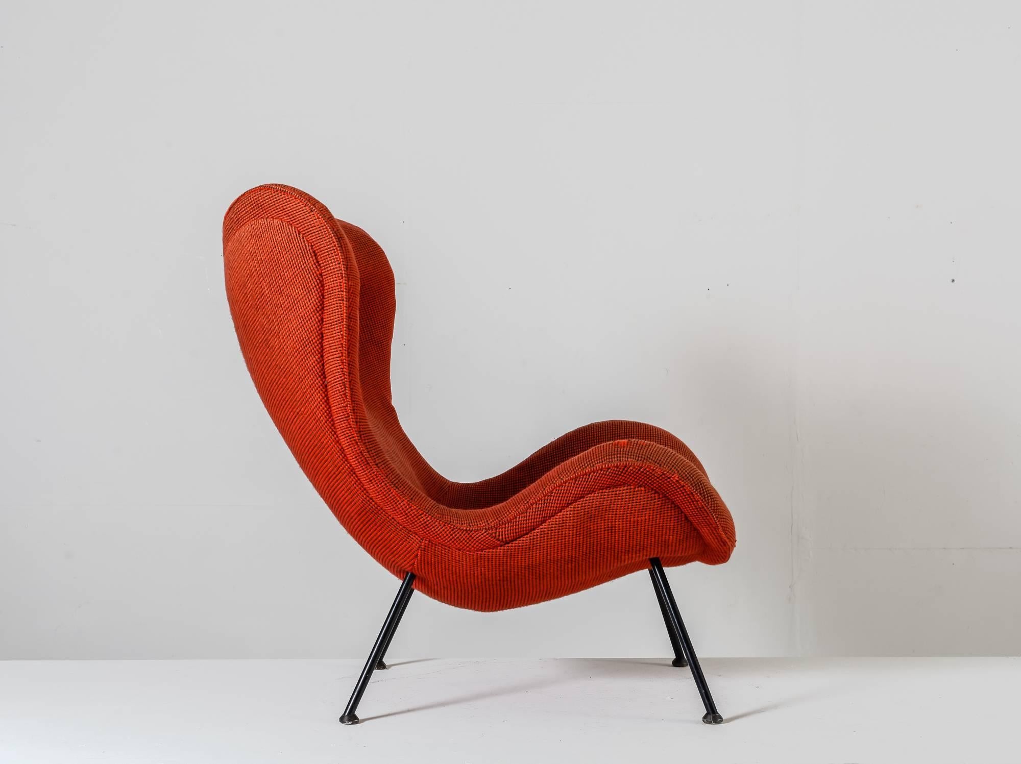 A red 'Madame' lounge chair with a high wingback by German designer Fritz Neth for Sitzformbau, Kassel, in the 1950s. The chair is made of a black lacquered tubular frame and has a red fabric upholstery.

The fabric of the chair has aged and the