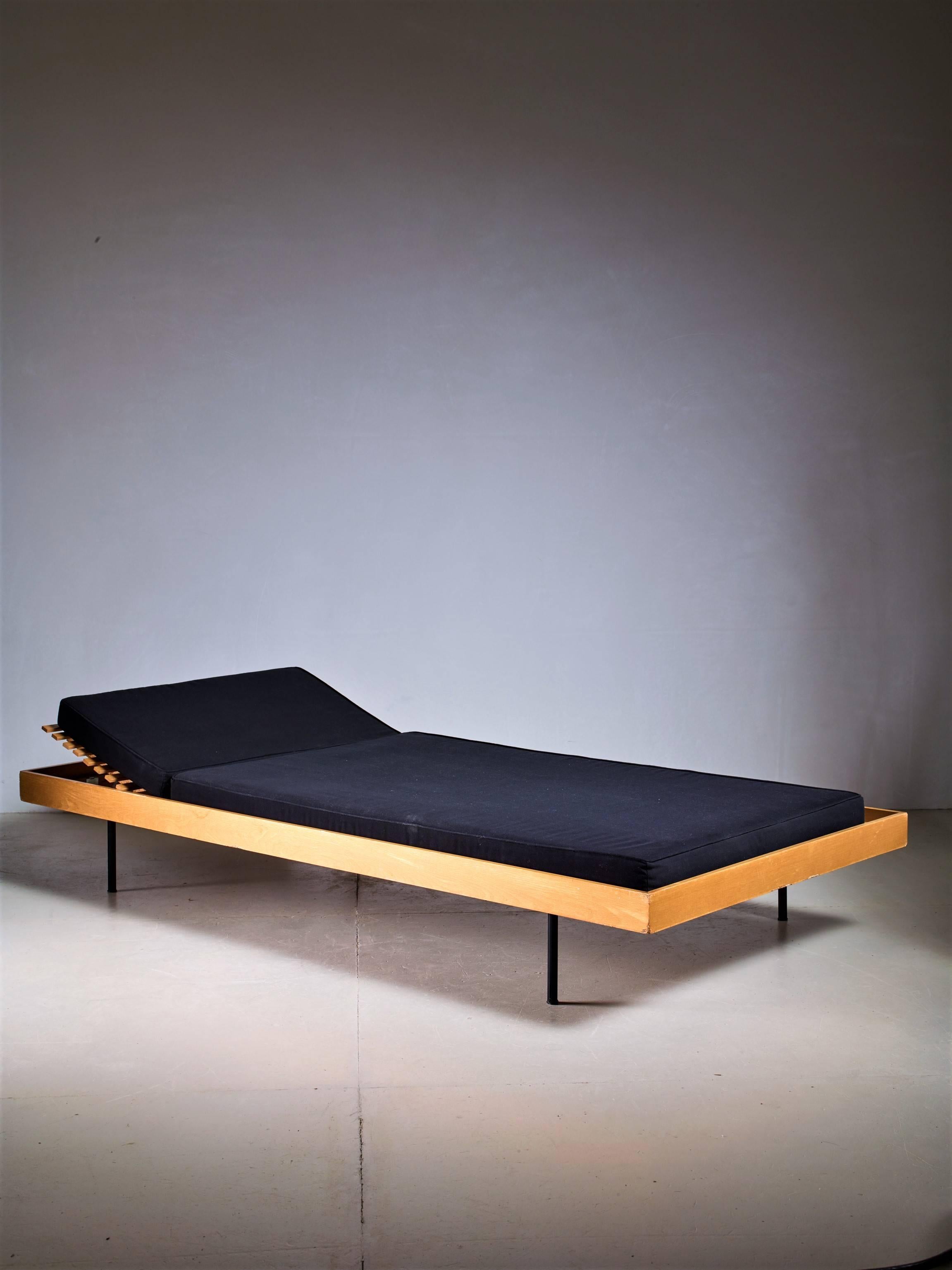 A wooden daybed with an adjustable headrest, for WK Möbel. The daybed is made of a wooden frame with wooden slats, standing on four thin black metal feet.

The mattress that is currently on the daybed is for image purposes only and not the correct