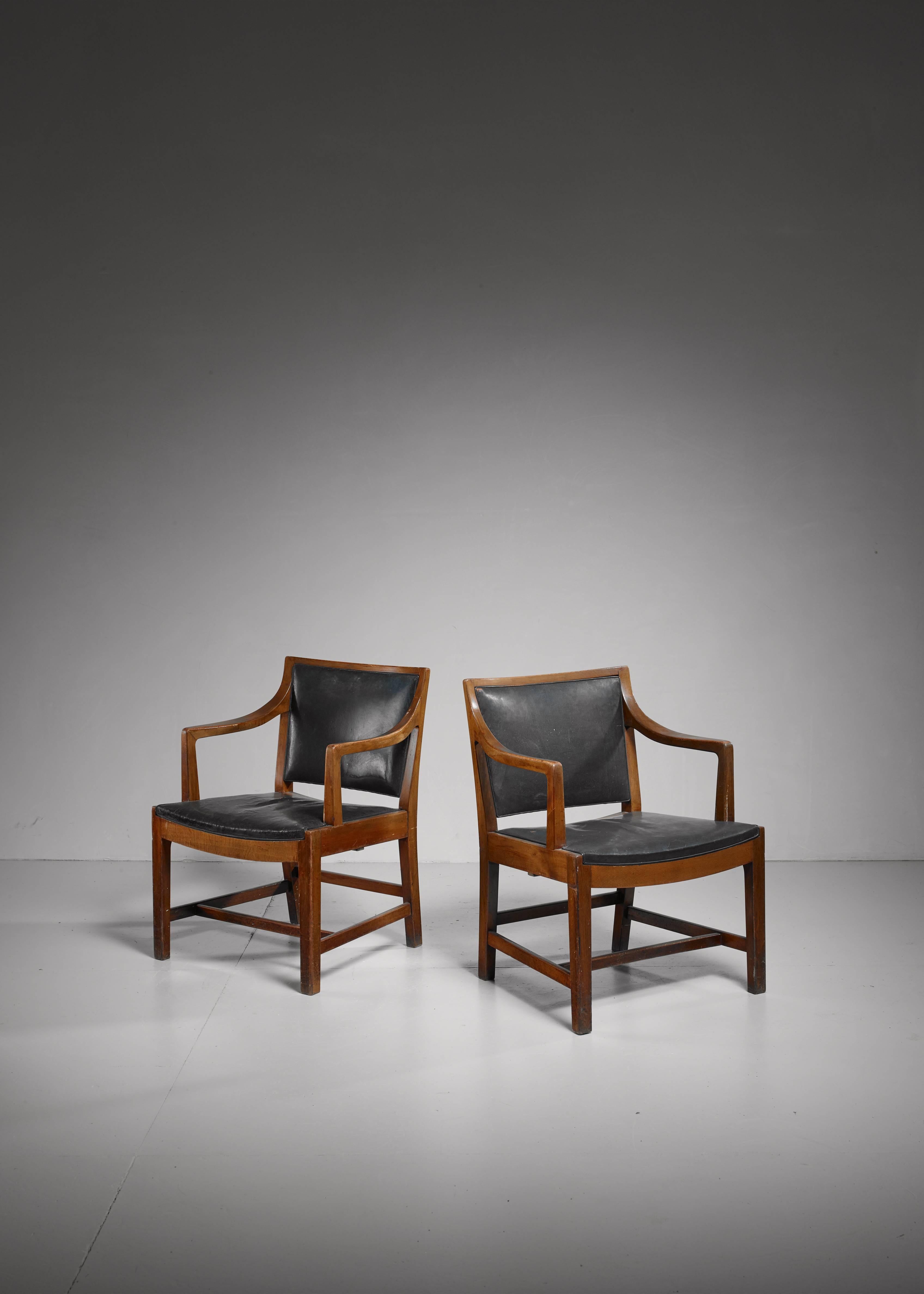 A rare pair of armchairs made of stained beech, upholstered with a dark green leather. These chairs were designed for and used on the Kronprins Frederik ferry (built 1941), which was furnished by Fisker. The model was later also used on the Kong