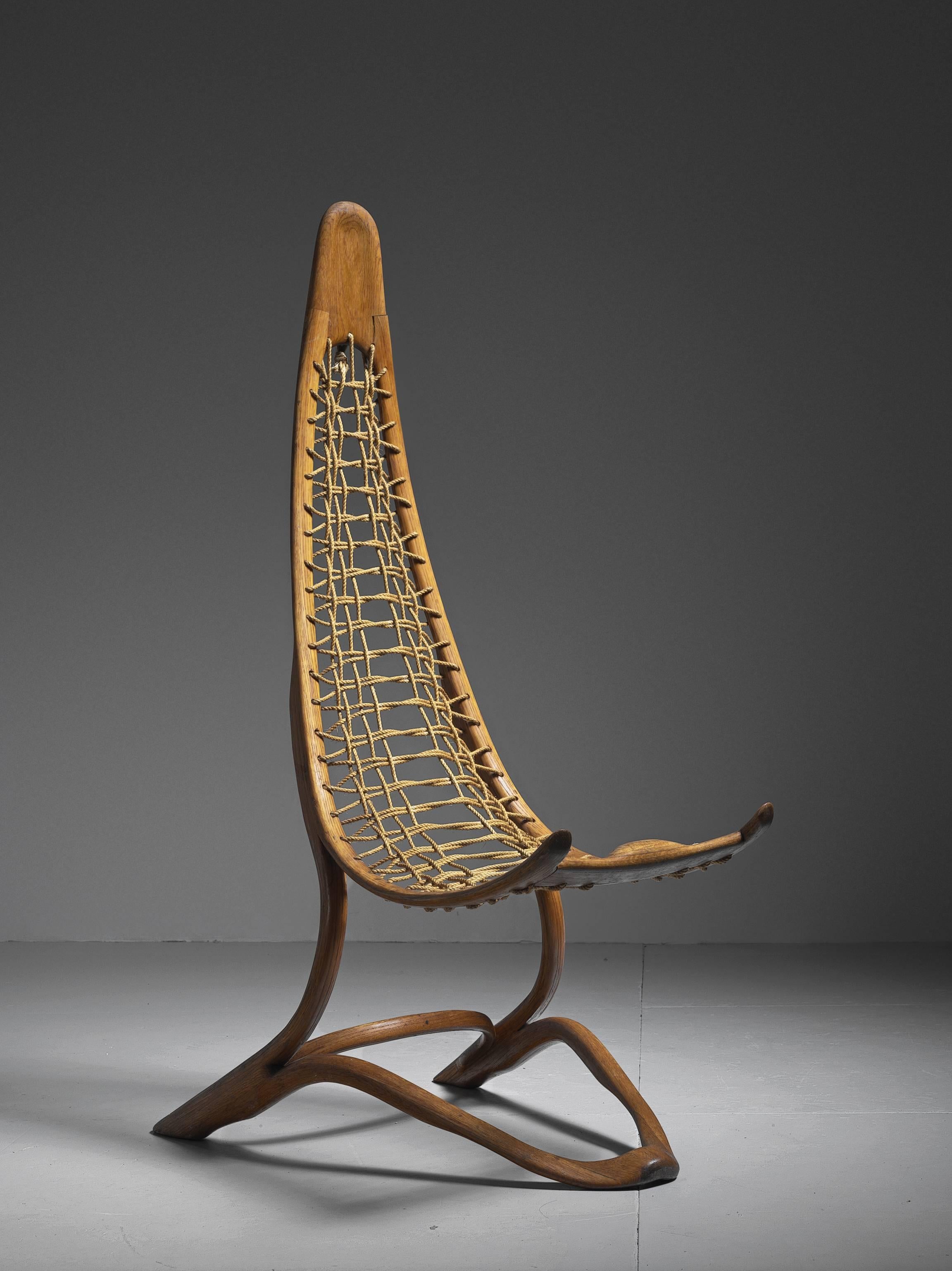 This amazing art piece or object chair combines ultimate woodworking skills and design quality. To create this large bow like bent plywood frame requires both knowledge of the material as the creativity to design this unique shape. The rough, woven