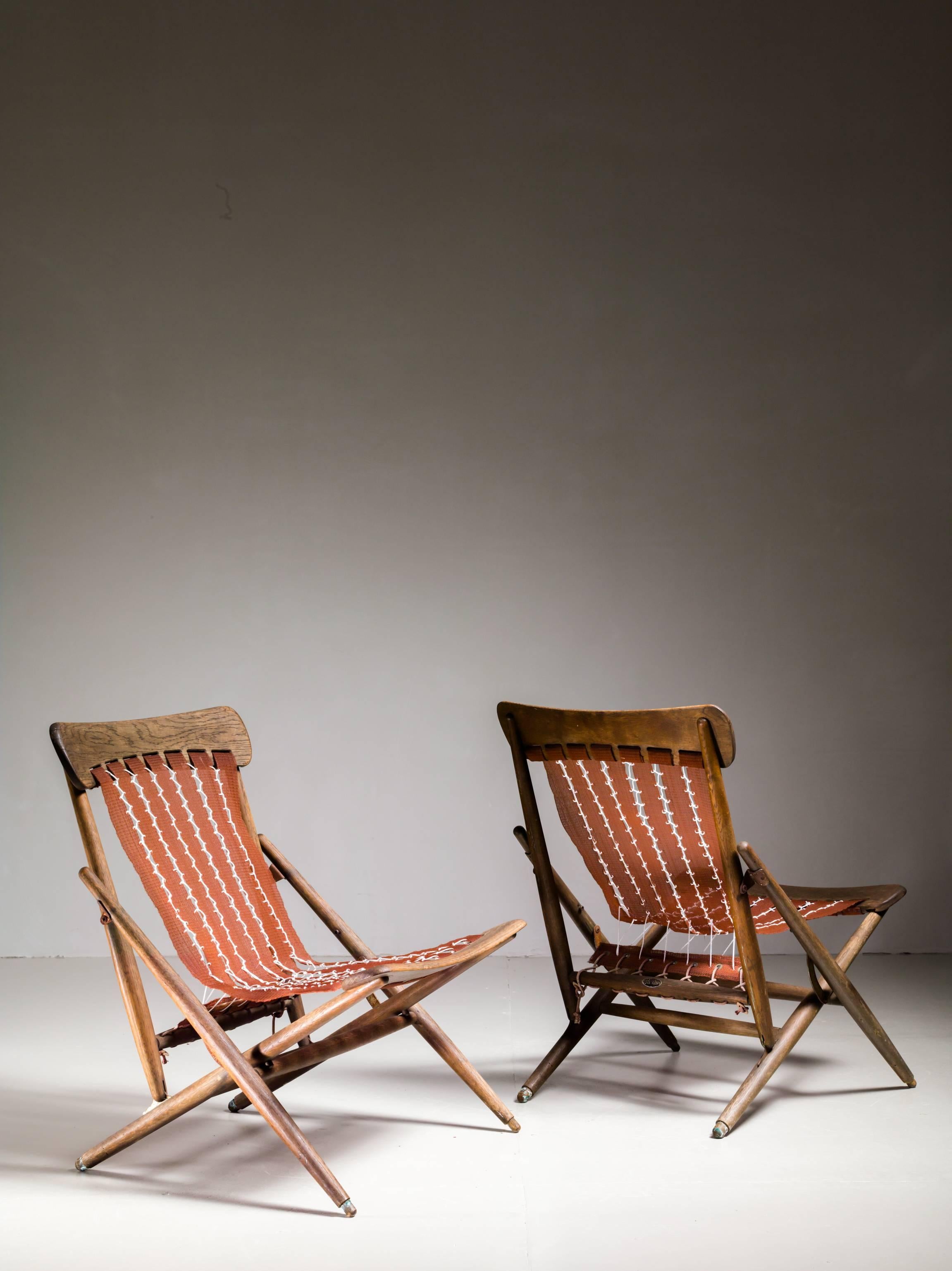 A pair of very rare foldable lounge chairs from the Maruni studio in Hiroshima.
The chairs are made of an oak frame and a sling seating of the original brown nylon mesh with new white cord. The wood is weathered from age, but still in a sound