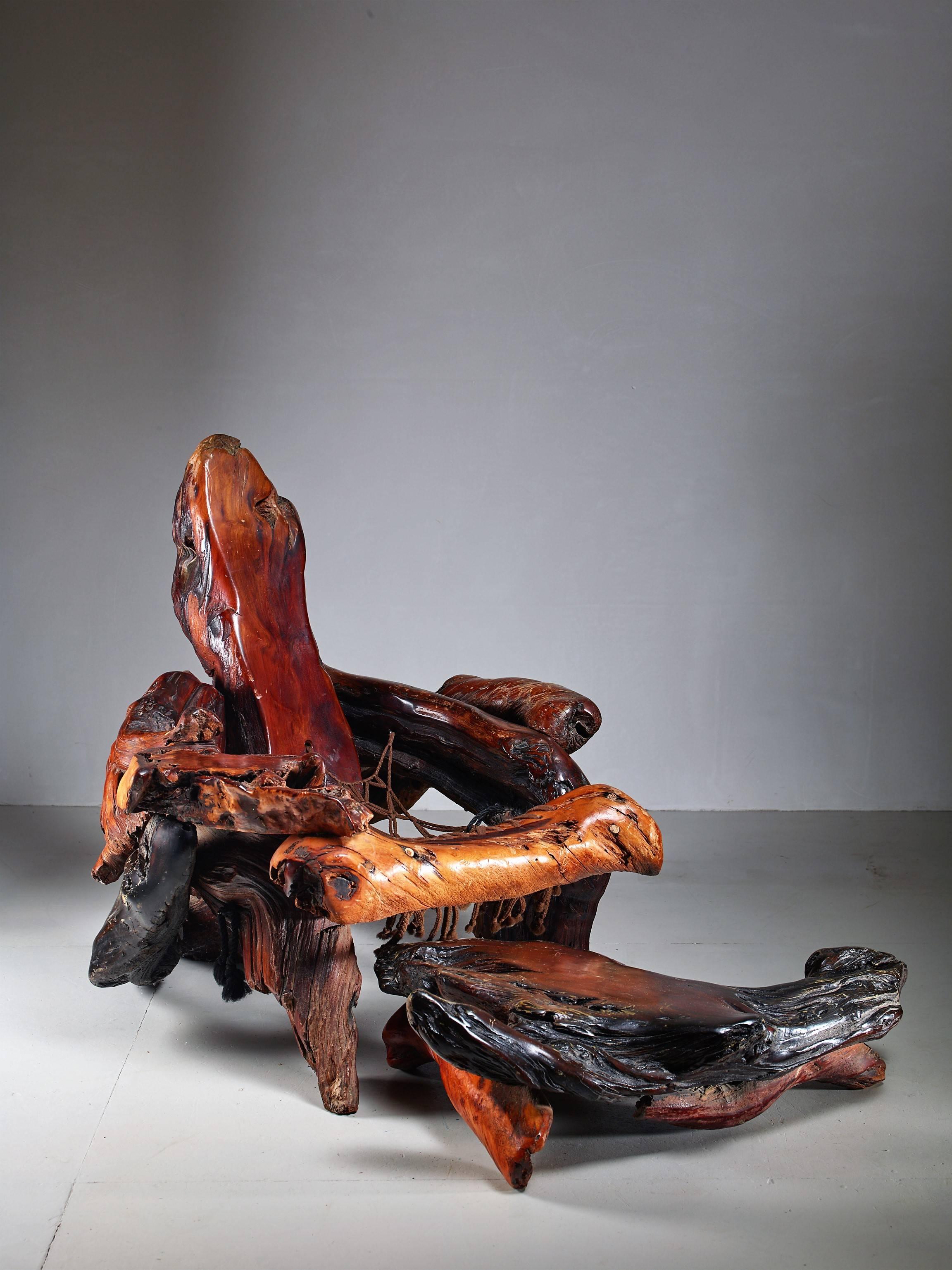 A sculptural, organically shaped chair with matching ottoman in redwood root.
The measurements stated are of the chair. The ottoman is 95 by 55 cm (37