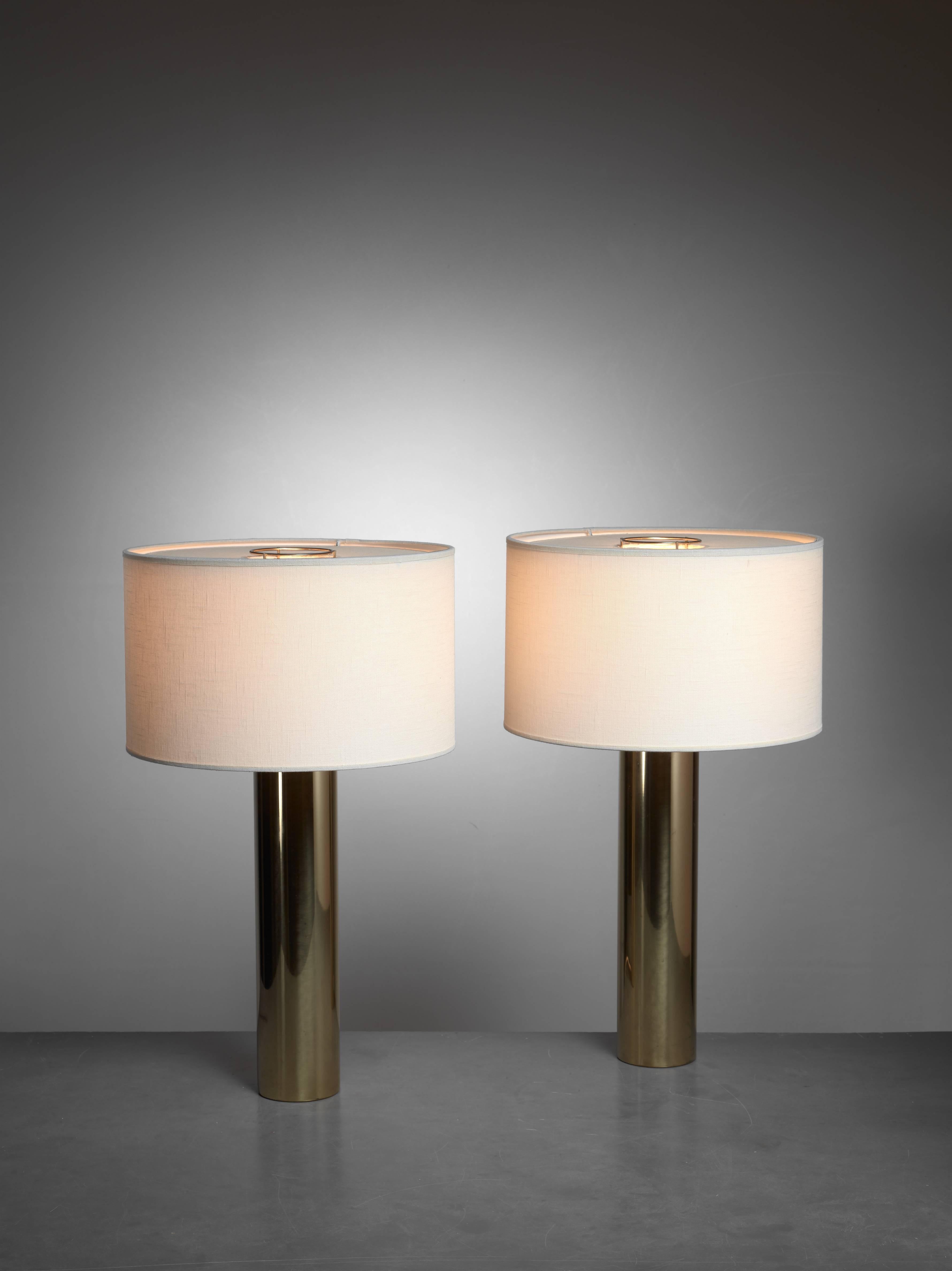 A pair of brass cylindrical table lamps by Falkenberg, Sweden. A beautiful rich and minimalistic set. A very beautiful base that can be tailored to the room by adjusting the color or shape of the shades.

The measurements stated are of the lamps