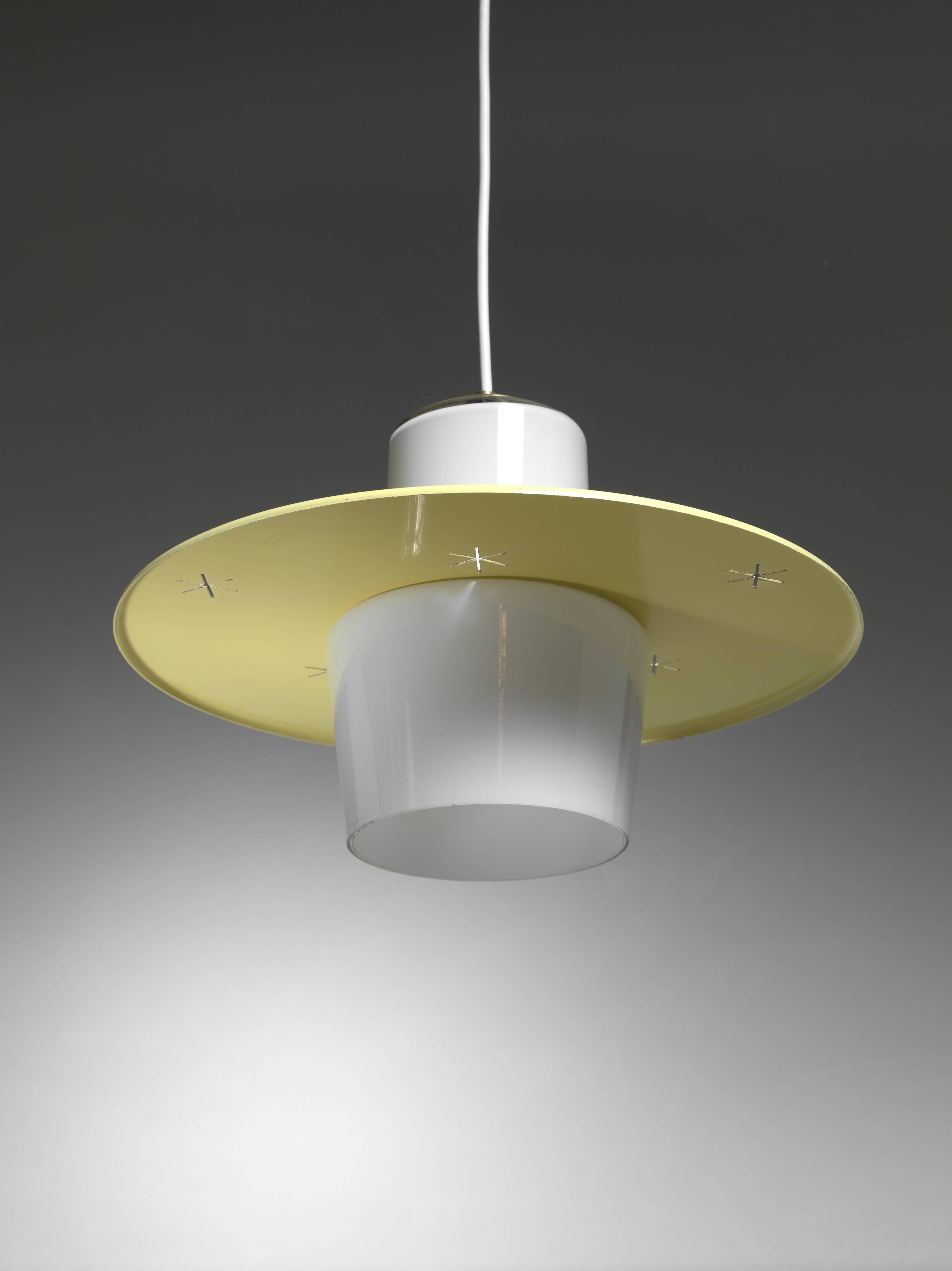 A model K2-23 pendant by Paavo Tynell. The lamp is made of a opaline glass diffuser with a round yellow metal shade with large star-shaped perforations. The lamp is marked by Idman and in an excellent condition.

Total drop can be adjusted to your