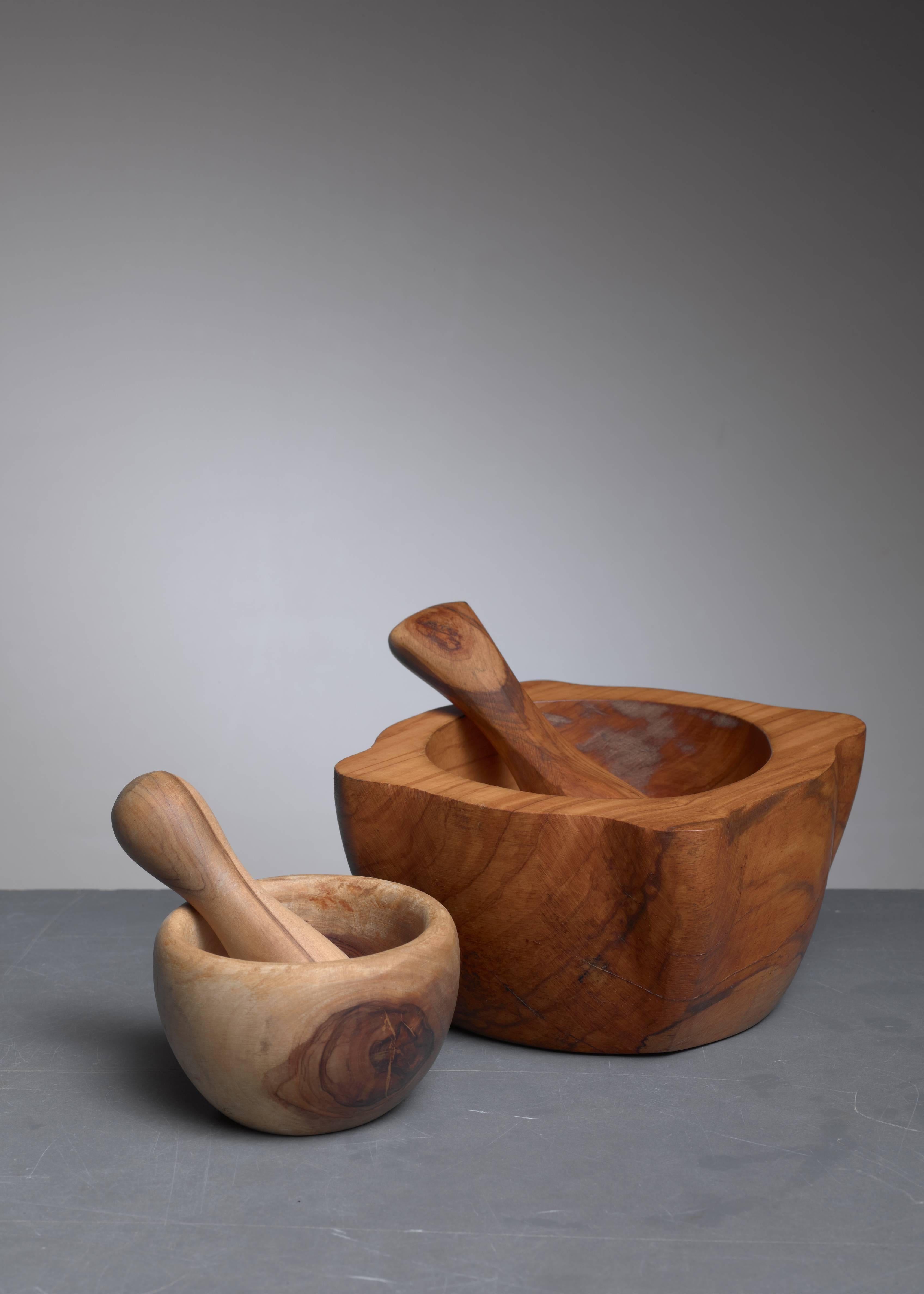 A pair of French wooden mortar and pestle sets. The sets are very decorative and pragmatic as they are useable. It is a joy to see and feel their beauty and free the natural smells from the herbs when using this Classic kitchen instrument. The