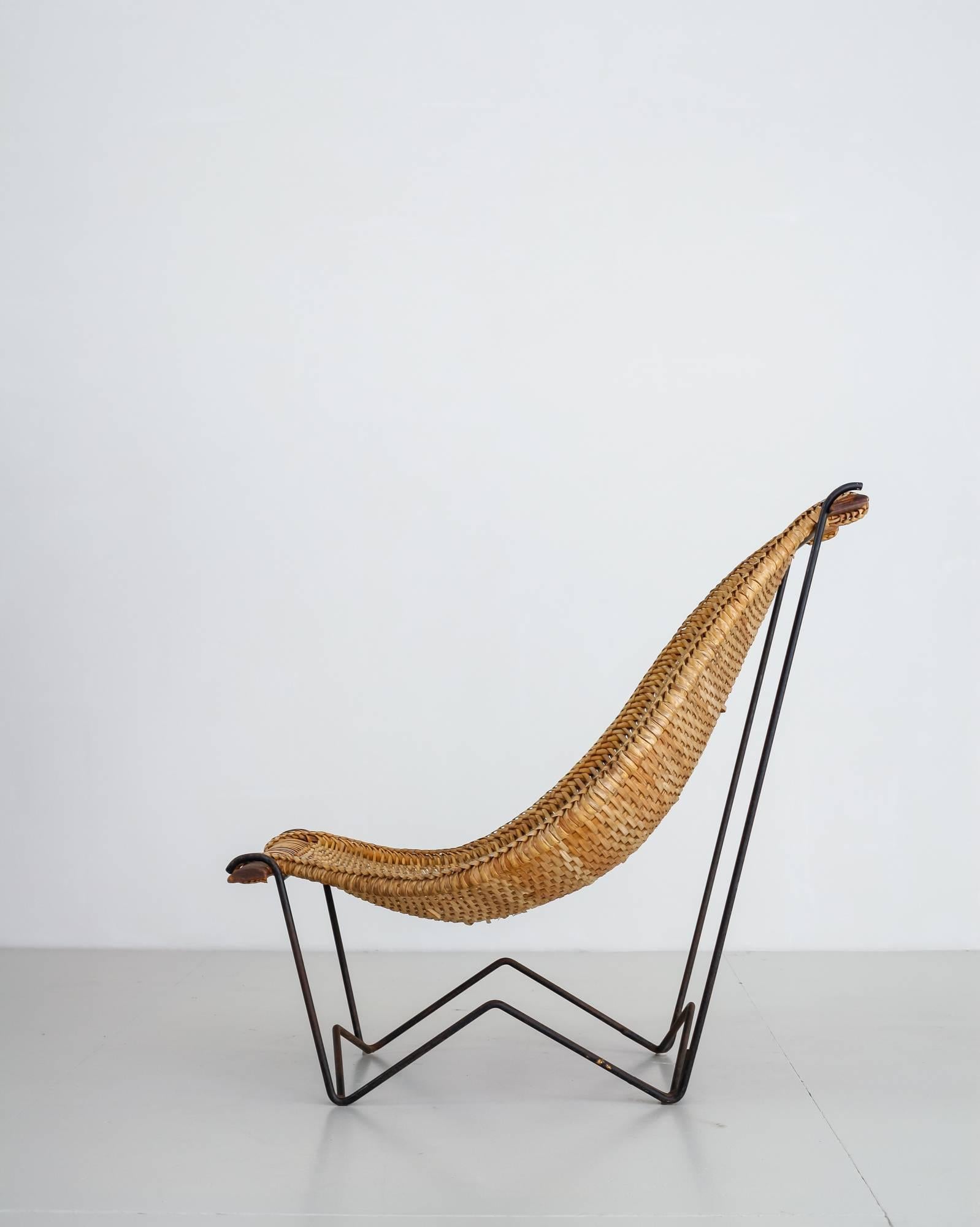 A 'Duyan' lounge chair by John Risley, made of a thin iron frame with a woven rattan sling seating. The hammock-like seating is fixed with two teak slats.
A beautiful chair combining Mid-Century American design and craftsmanship. Both a sculptural