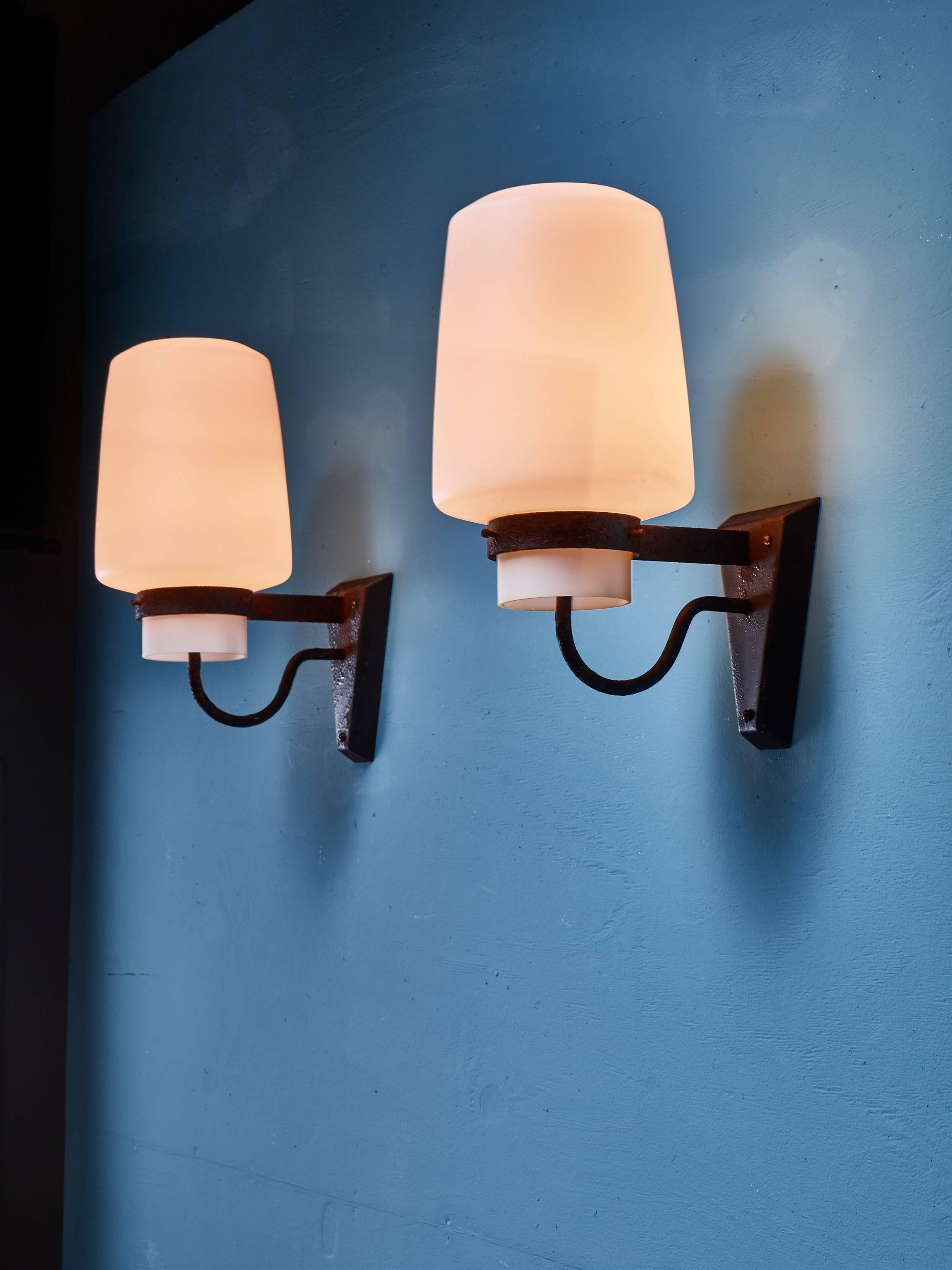 A pair of wall sconces by Georges Candilis. The lamps are made of a metal wall mount, holding an opaline glass diffuser (28 cm high and an 18 cm diameter).
These pieces are part of a larger lot of items from the Les Carrats resort in Port-Leucate,