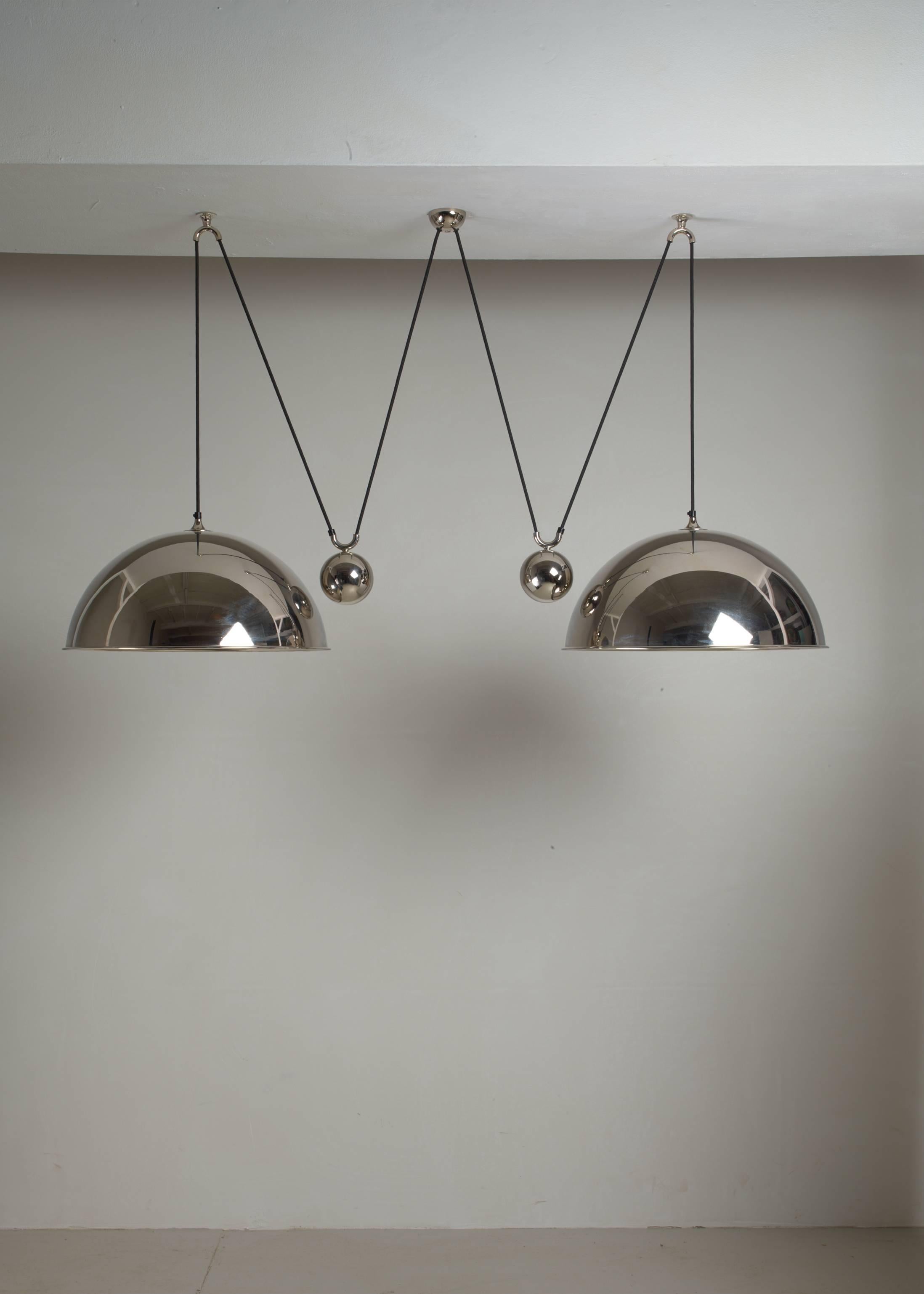 A Florian Schulz double 'Posa' pendant lamp with two shades and two counterweights. The lamps are made of nickel-plated brass.
The measurements stated are of one shade.

 