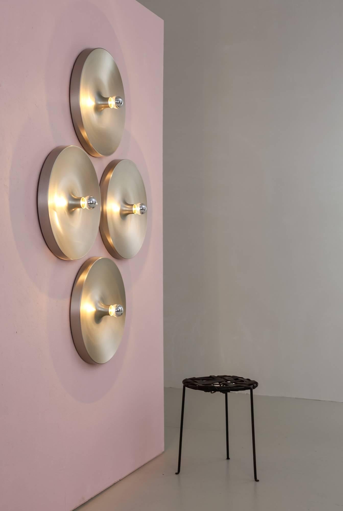Mid-Century aluminum flush mount wall or ceiling lamps by Honsel Leuchten, Germany. These Minimalist lamps are made of a round and convex, spun aluminum shade with the visible light bulb in the centre.
Charlotte Perriand used this lamp in apartments