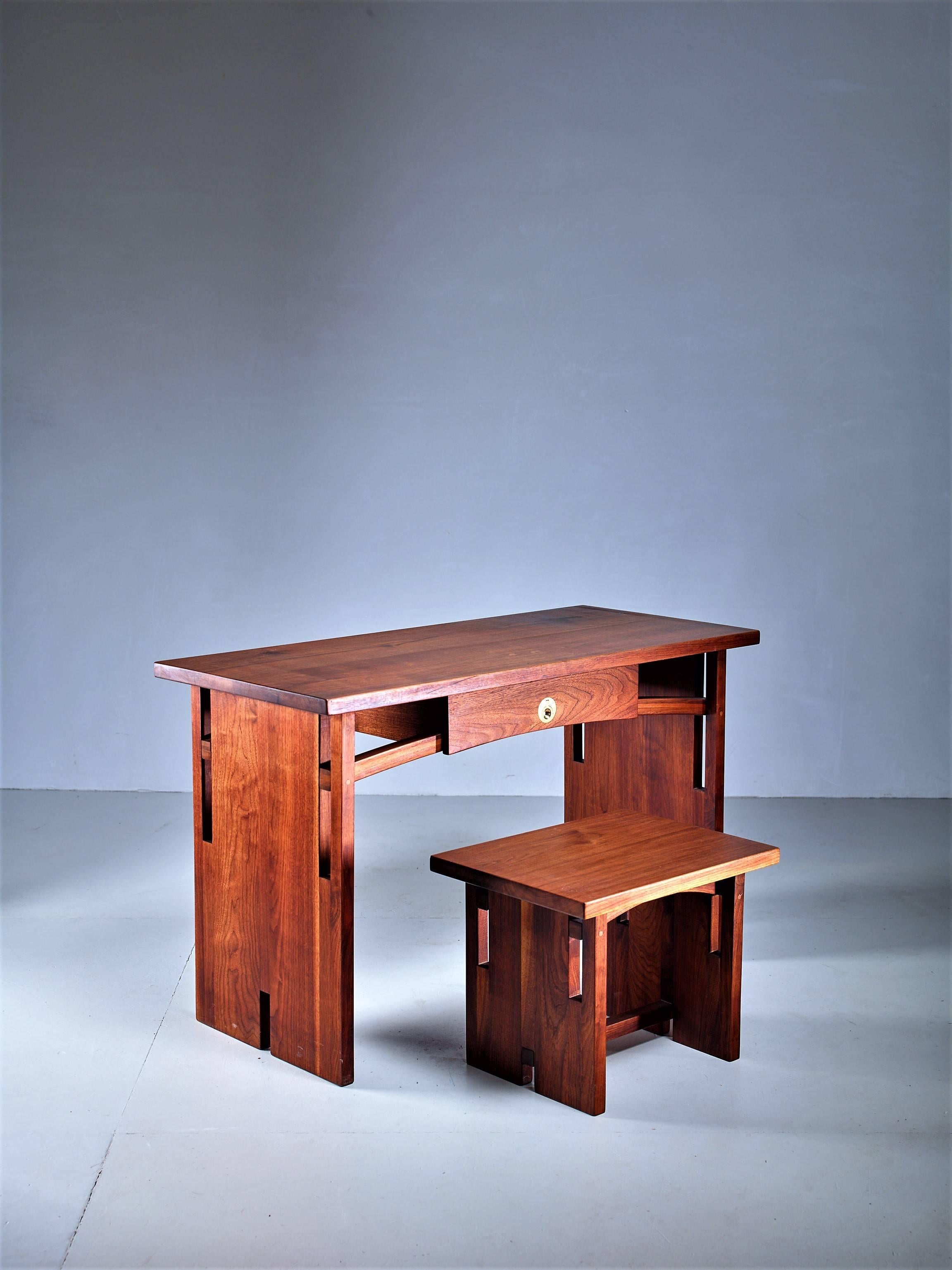 A small walnut desk with a drawer with a brass pull and a matching stool by David Barr.


 The stool is 52.5 (20.5
