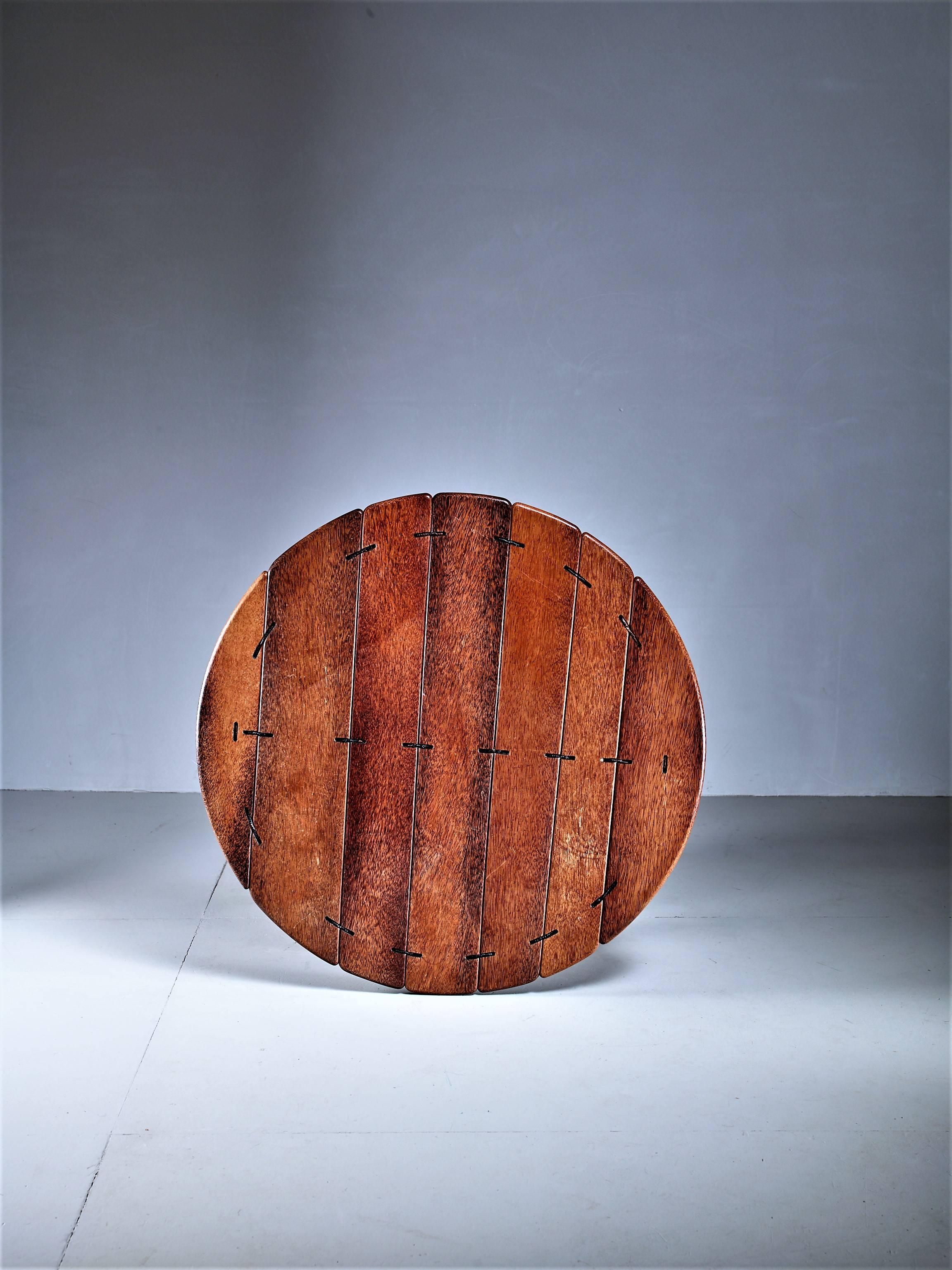 A large and round studio crafted coffee table in palmwood, from Australia
The table has a steel frame and the wood parts are connected with rope and leather.
