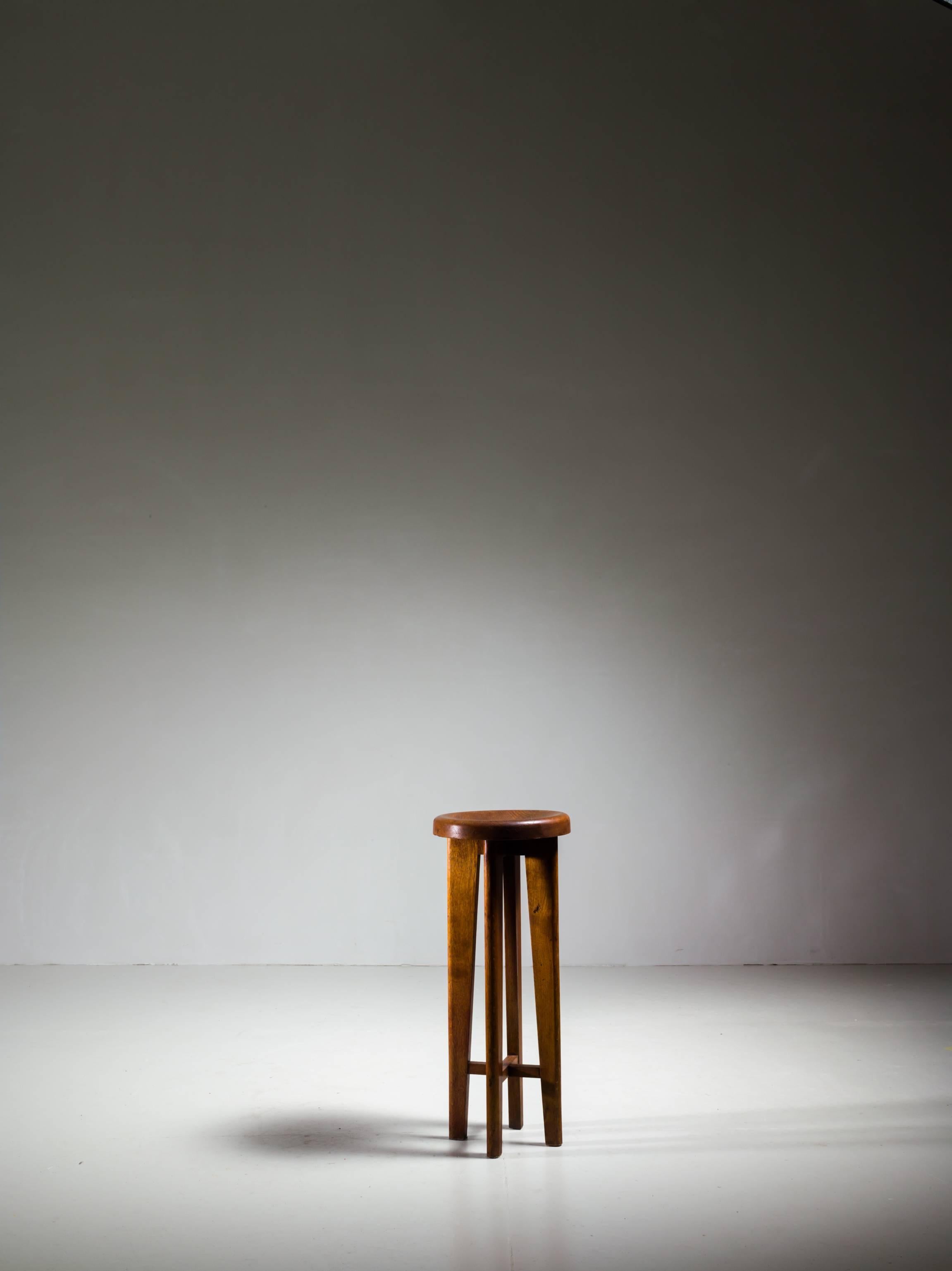 A high French stool in solid oak. High, architectural legs and a wonderful inward curved seat. A beautiful piece with a stunning patina. The stool is reminiscent of the work of Charlotte Perriand and Pierre Jeanneret.
