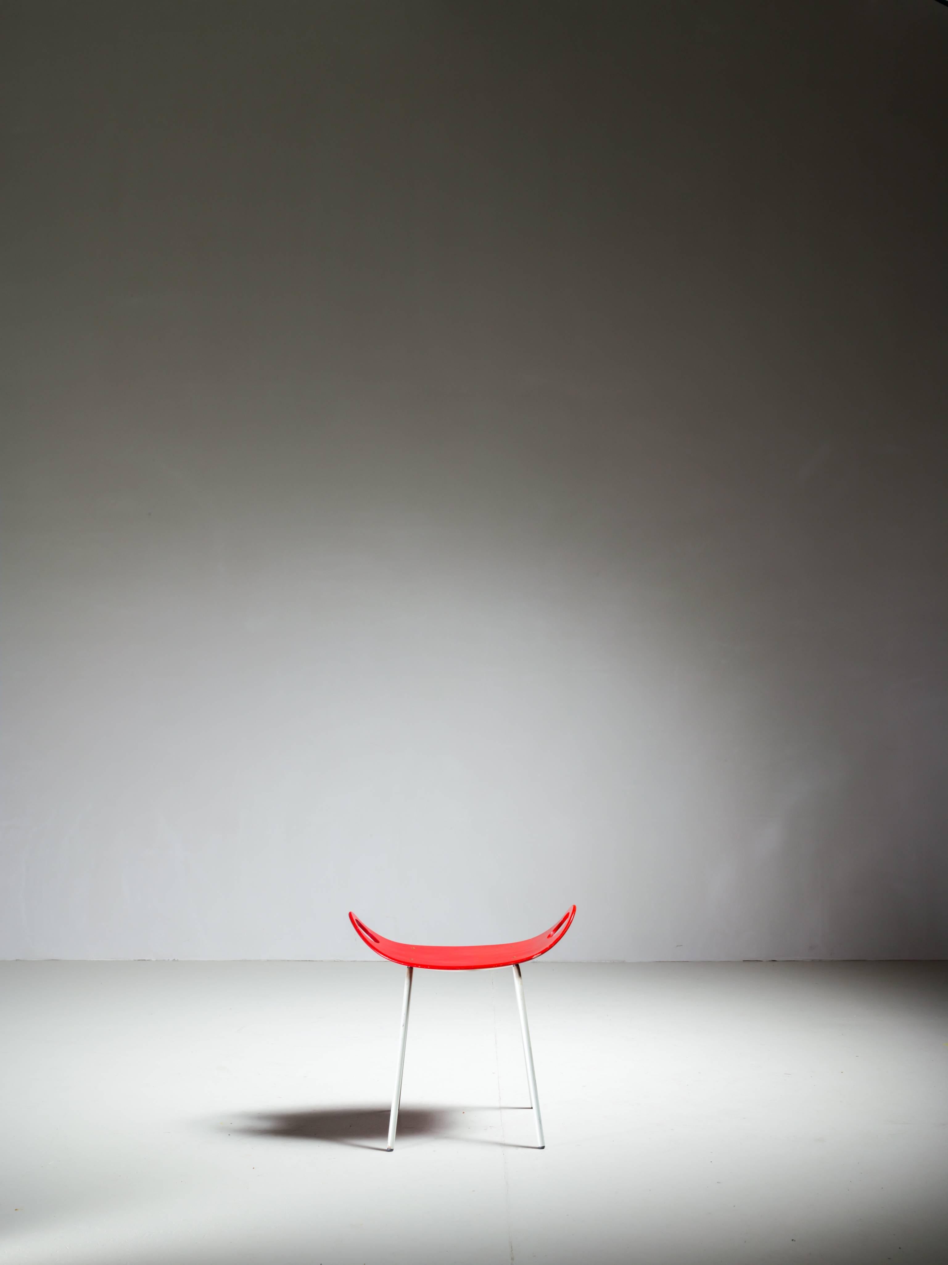 A 1950s stool by Olof Kettunen for Merivaara, Finland.
The stool is made of white tubular metal legs and a red lacquered plywood seat which curves upwards.
A simple and elegant design in a lovely condition.
