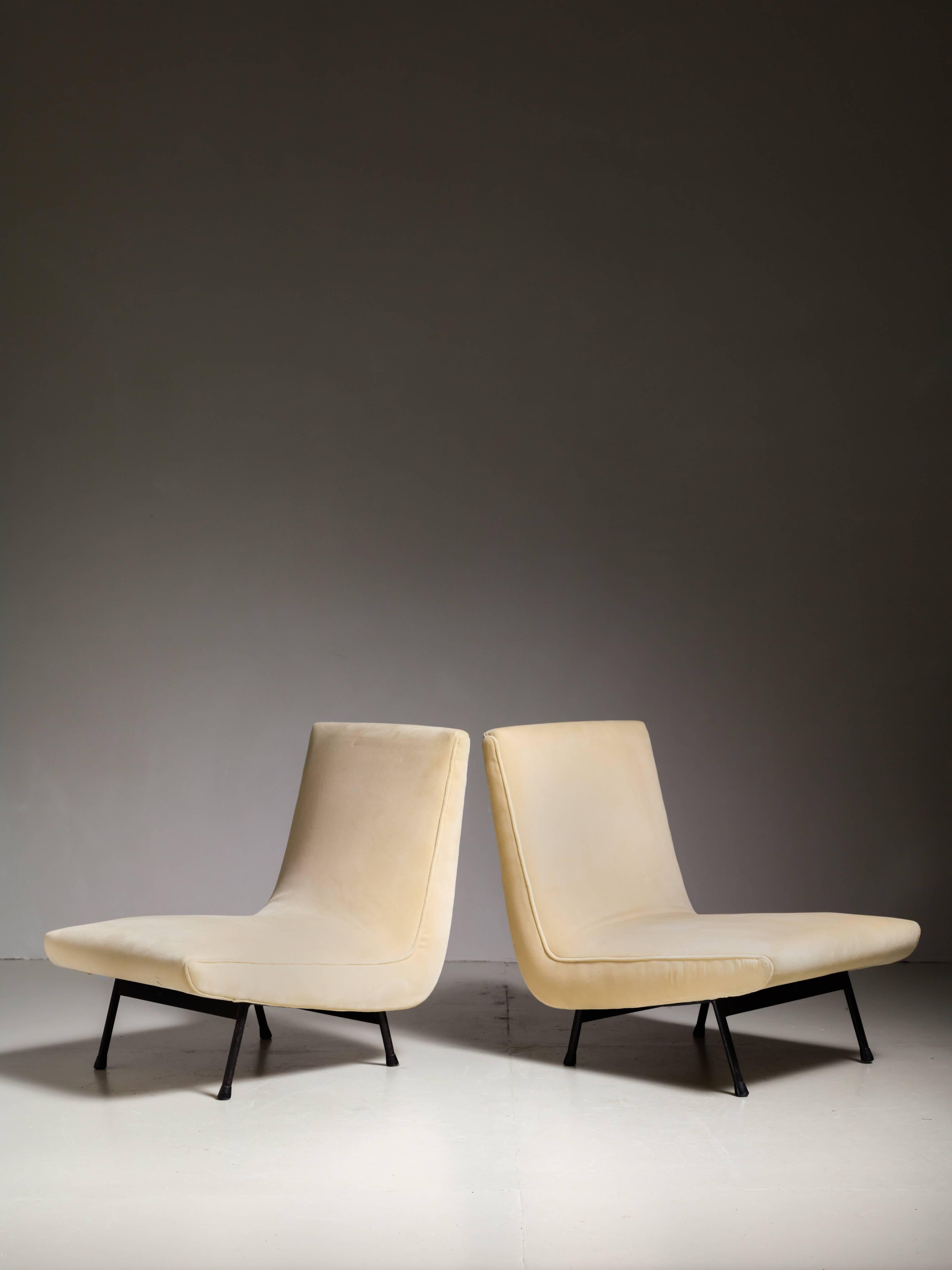 A wonderful pair of low lounge chairs. They were reupholstered in a cream white heavy velvetlike fabric, close to the original. Original and perfect singles. Excellent condition.