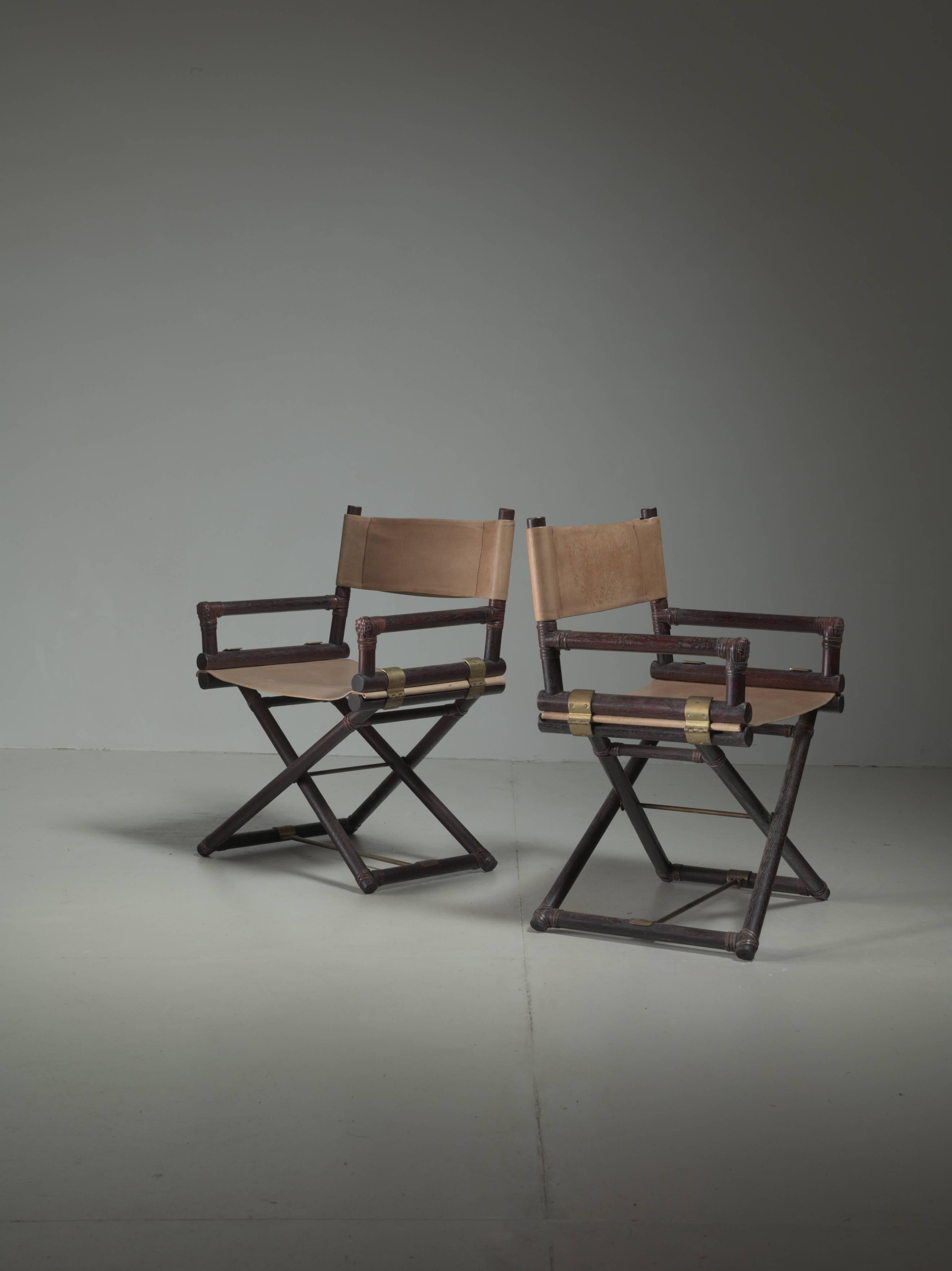 A pair of director's chairs made of stained ash and a sling leather seating and backrest. The connections are made of brass and leather cord.
This model was designed in 1956 for the McGuire Furniture company.
