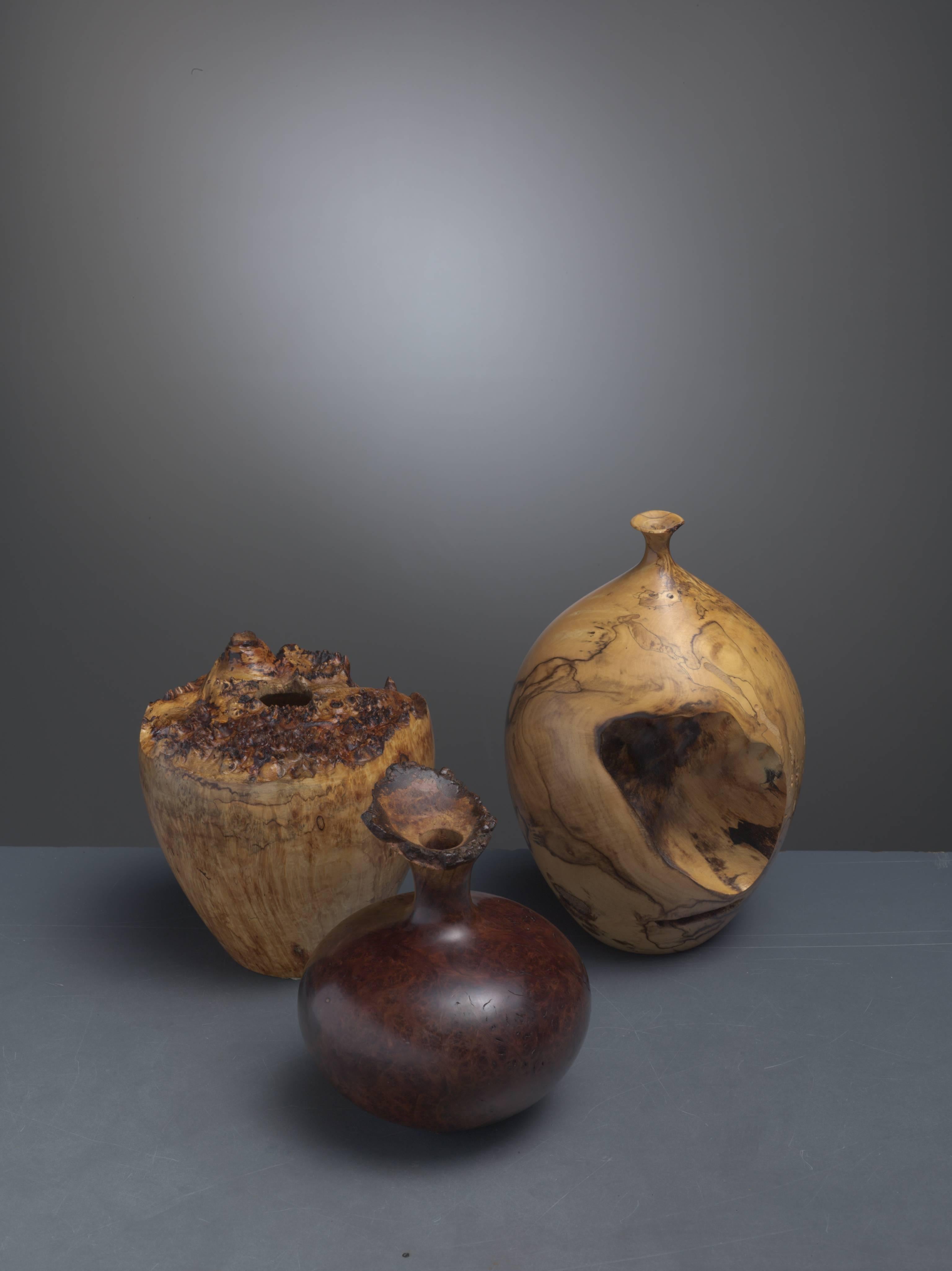 A set of three turned vases from different types of burl wood. The set consists of these pieces:

A vase with a very small opening by Hap Sakwa in buckeye. Signed by Sakwa with the year of production (1980). Measures: Diameter of 12.5 cm and 19 cm