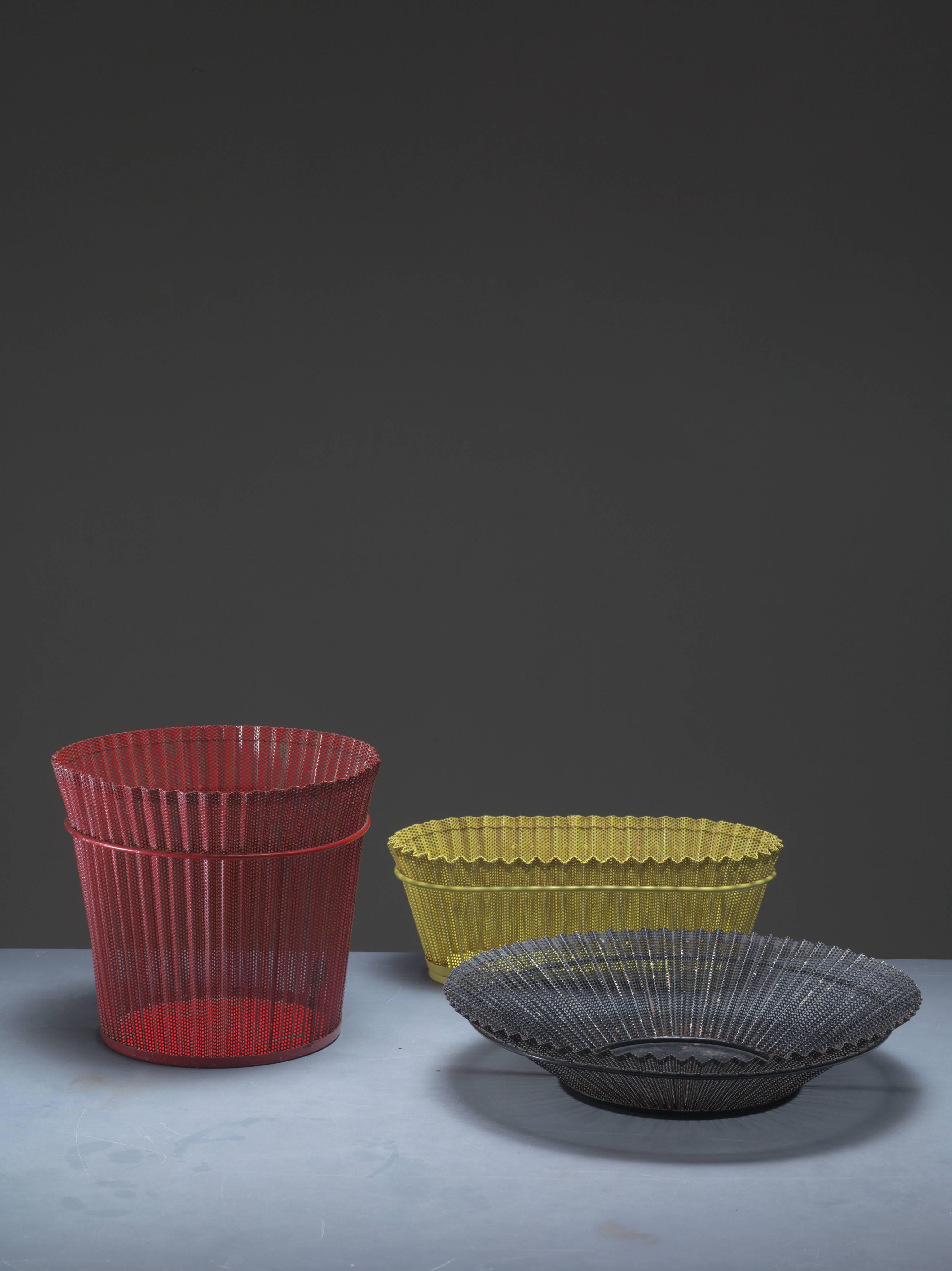 A combination of two Mid-Century metal bins and one bowl by Mathieu Matégot in red, yellow and grey. All three made of pleated and perforated enameled metal, typical for Mathieu Matégot's designs.
Dimensions of the bowl: 37.5 diameter and 7 cm