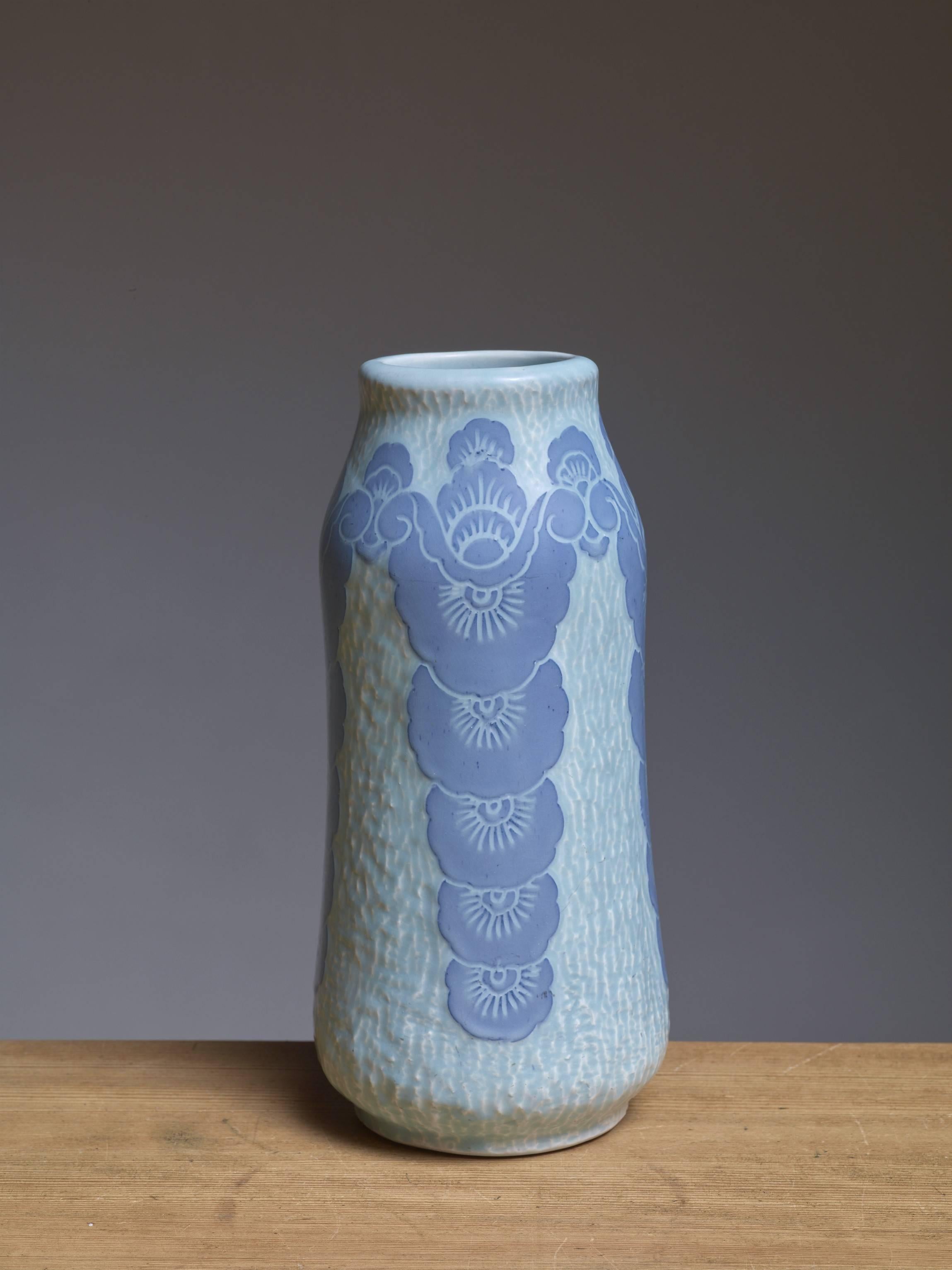 A ceramic vase by Swedish artist Josef Ekberg (1877-1945) for Gustavsberg. The vase has a blue glaze finish with a Sgraffito flower motif.
