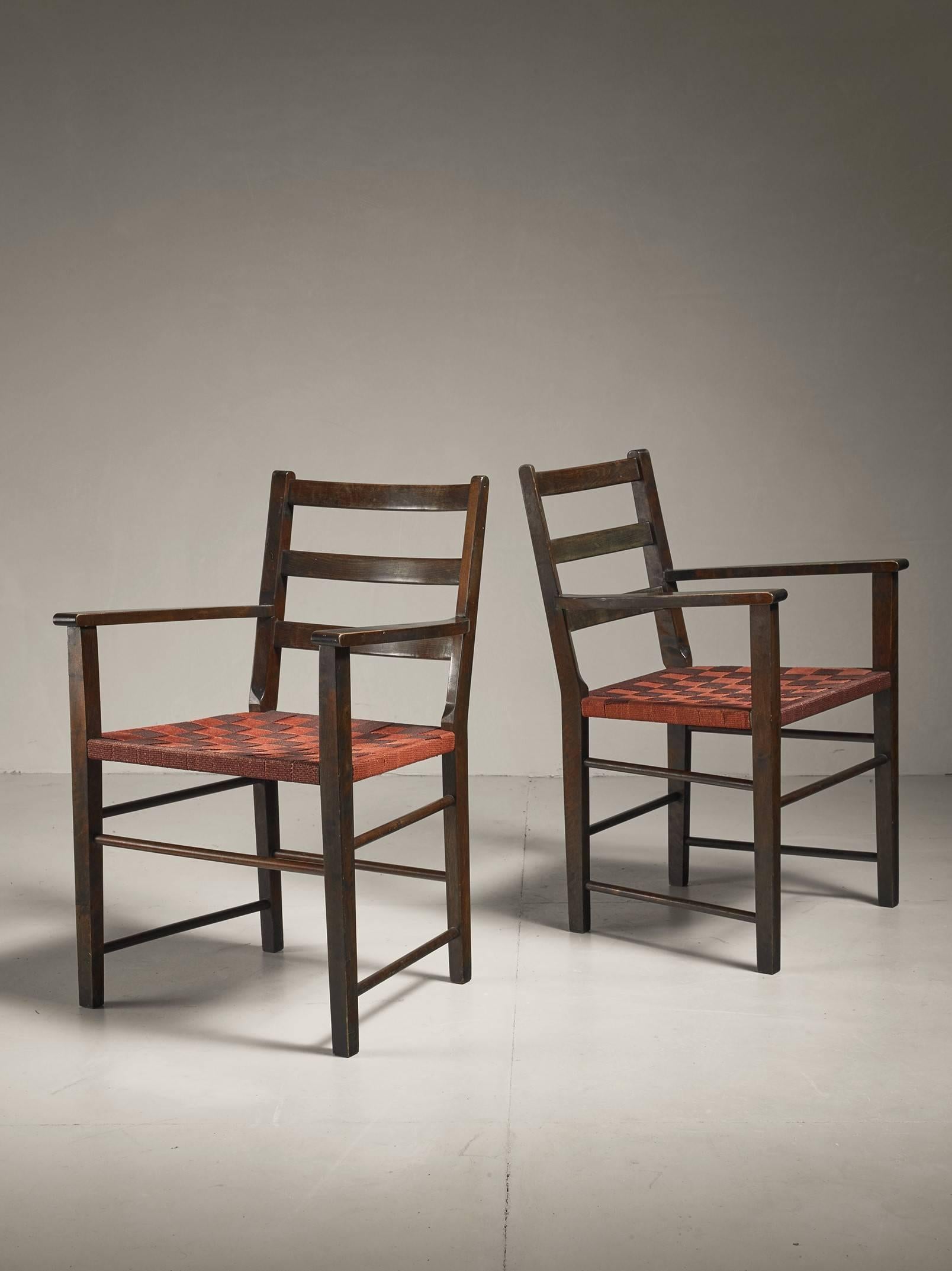 A pair of armchairs by Gemla and attributed to Axel Larsson. The chairs are made of a stained birch frame with a brown and red webbed canvas seating.
Labeled by Gemla and in a good condition.